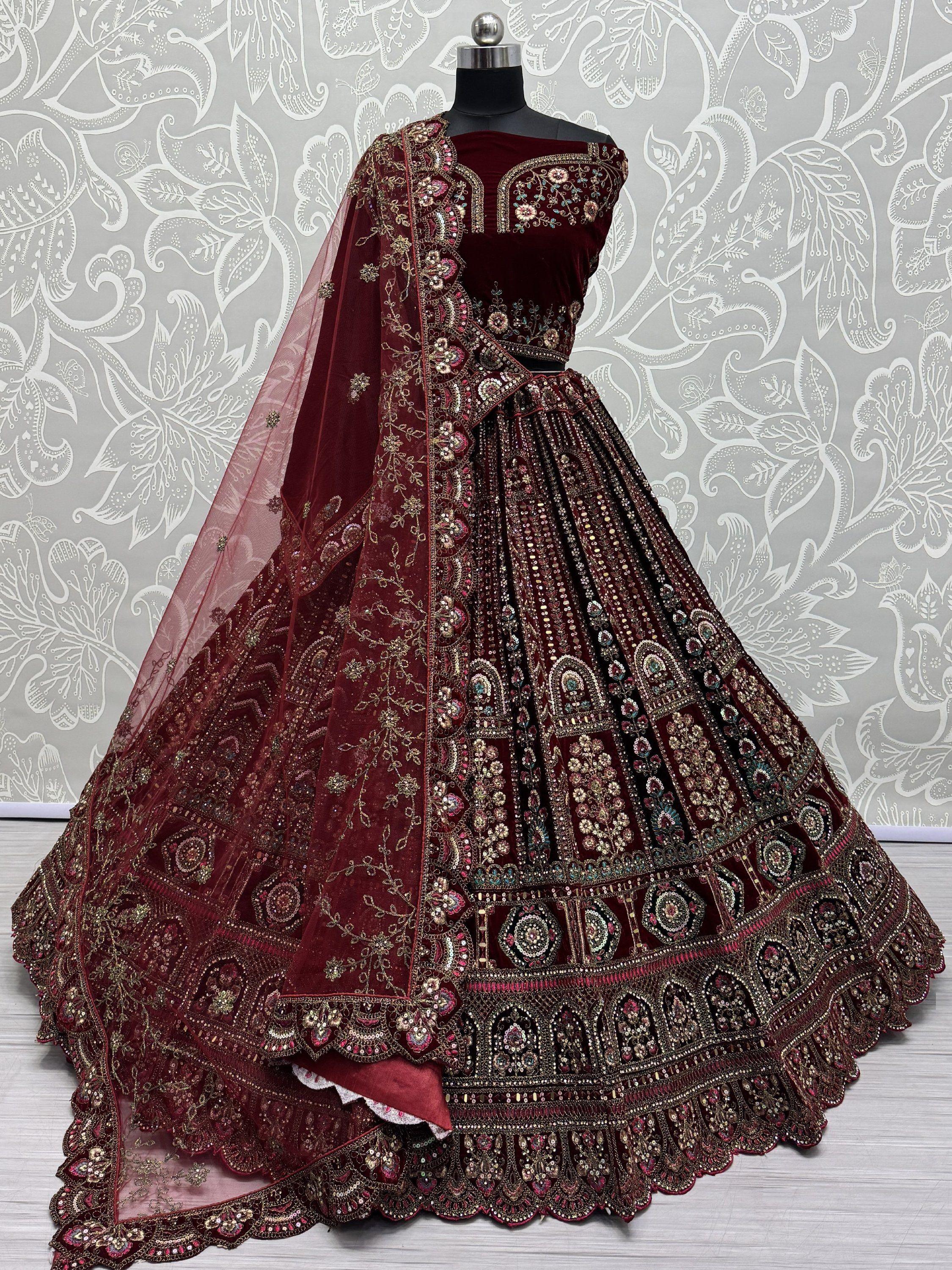 Maroon bridal lehenga choli with heavy gold foil embroidery and matching dupatta on mannequin