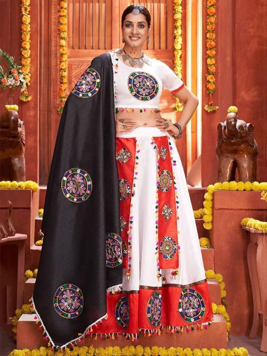 Woman wearing embroidered muslin silk Navratri lehenga choli with dupatta, festive decor