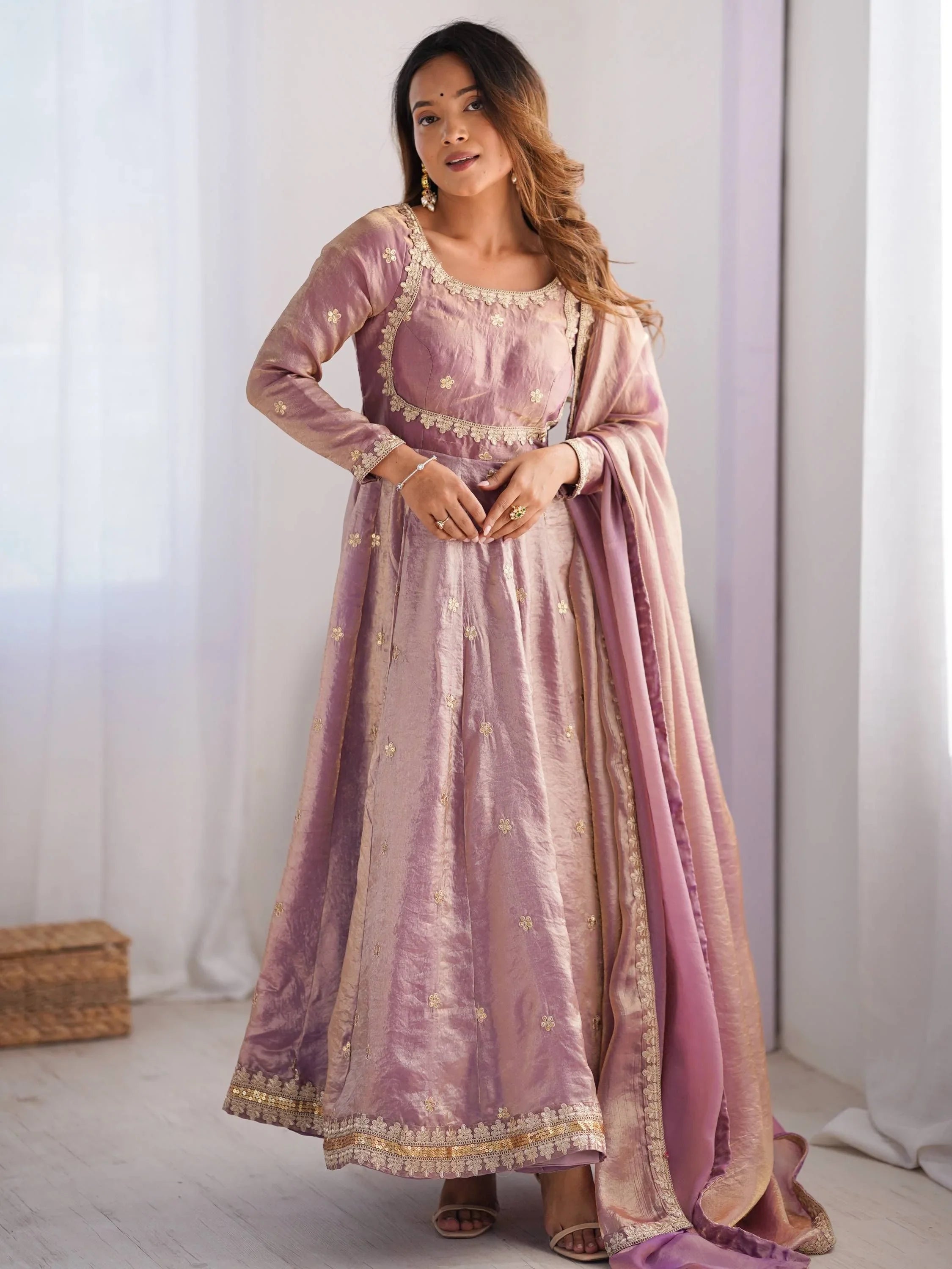 Woman wearing mauve taffeta engagement gown with gold embroidery and matching dupatta