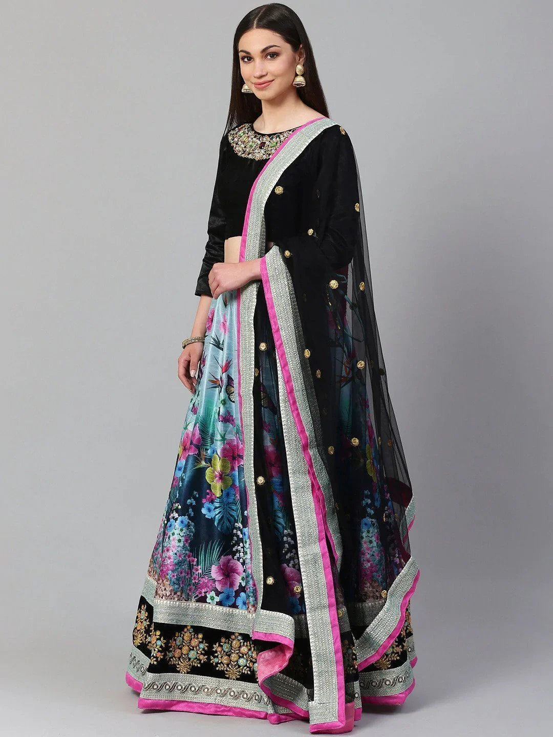 Woman wearing black velvet floral lehenga choli with embroidered dupatta and ethnic jewelry
