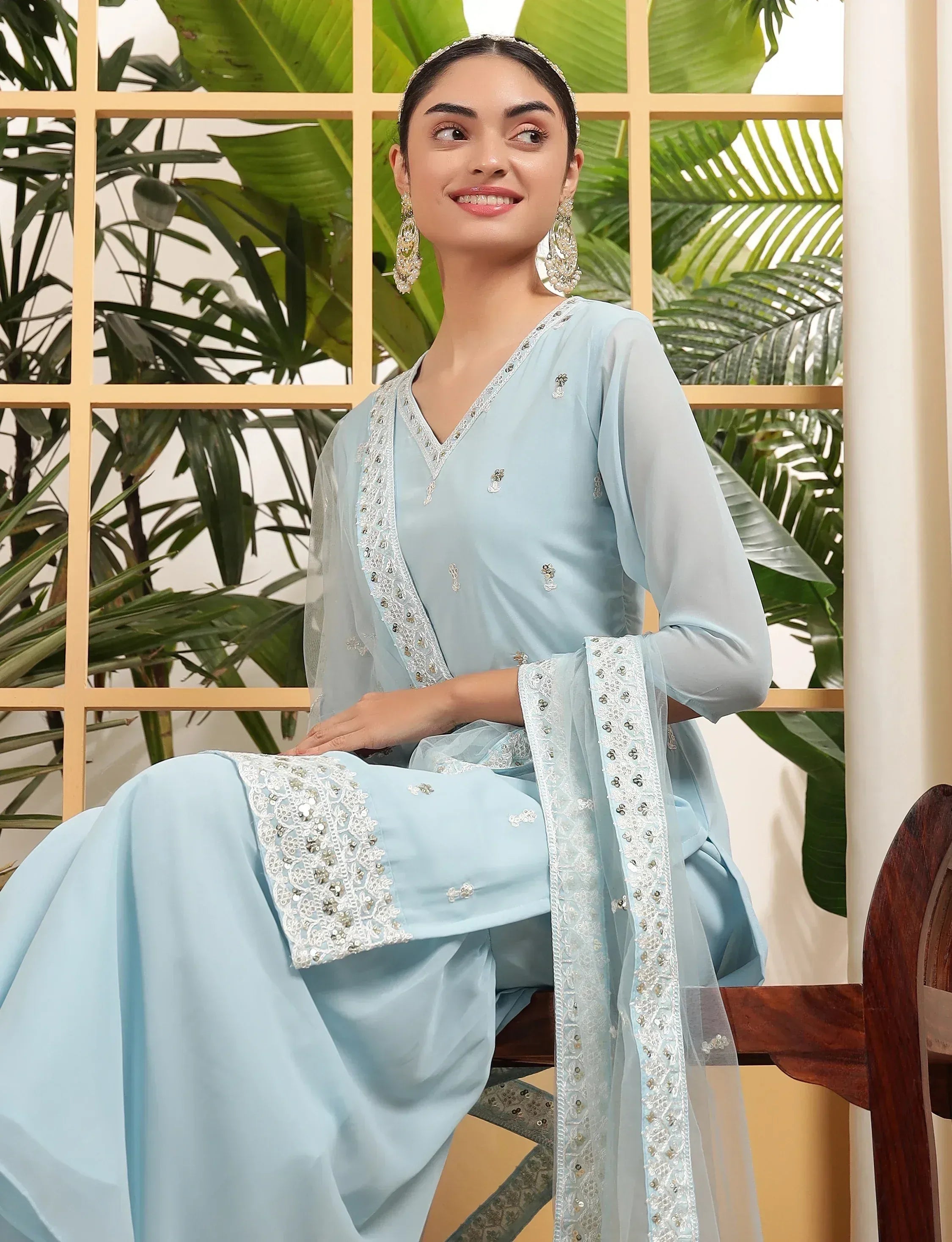 Light blue embroidered salwar kameez with lace detailing, perfect for Indian ethnic wear occasions.