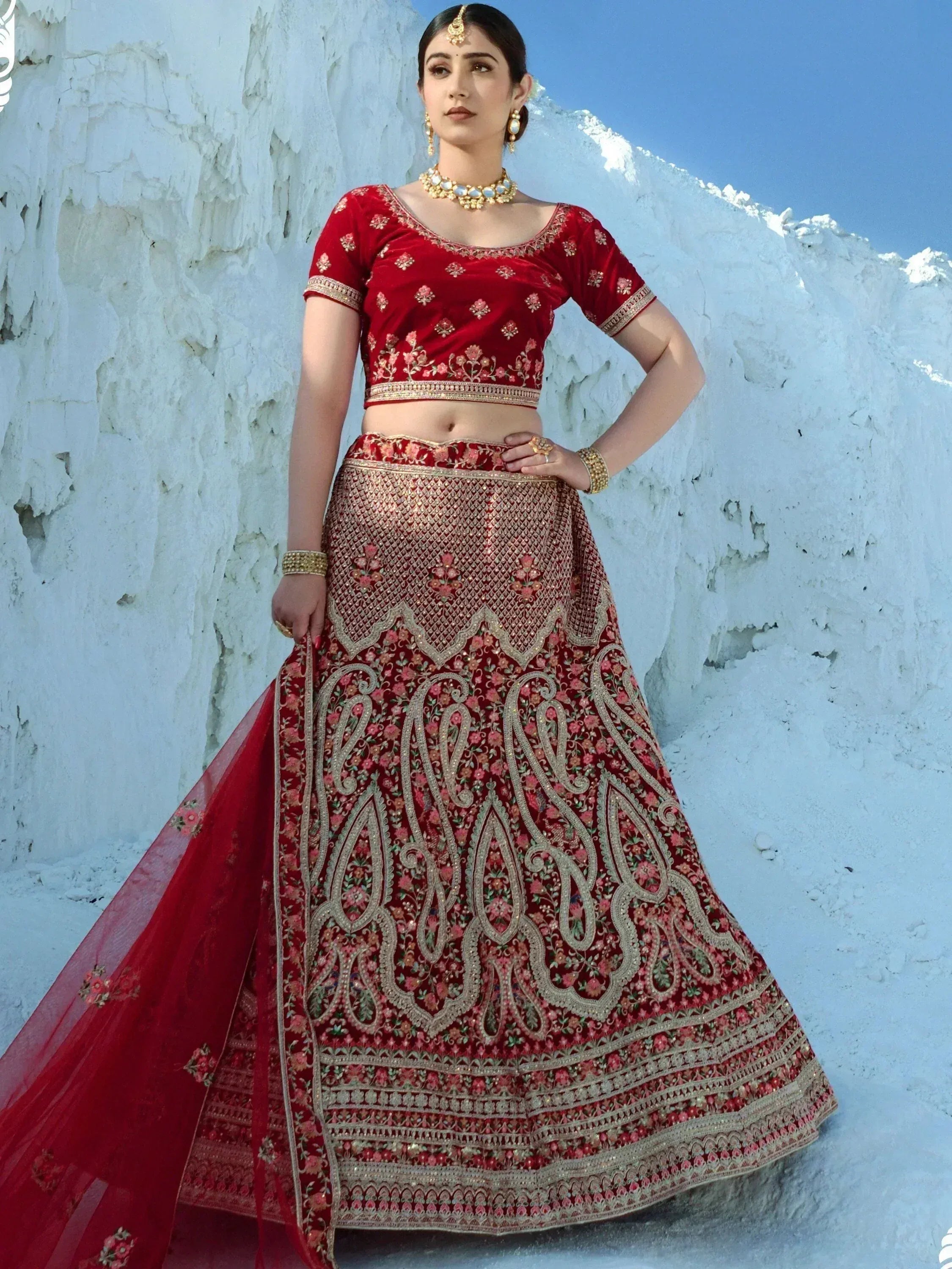 Red embroidered lehenga choli with gold detailing, perfect for Indian weddings and festive occasions.