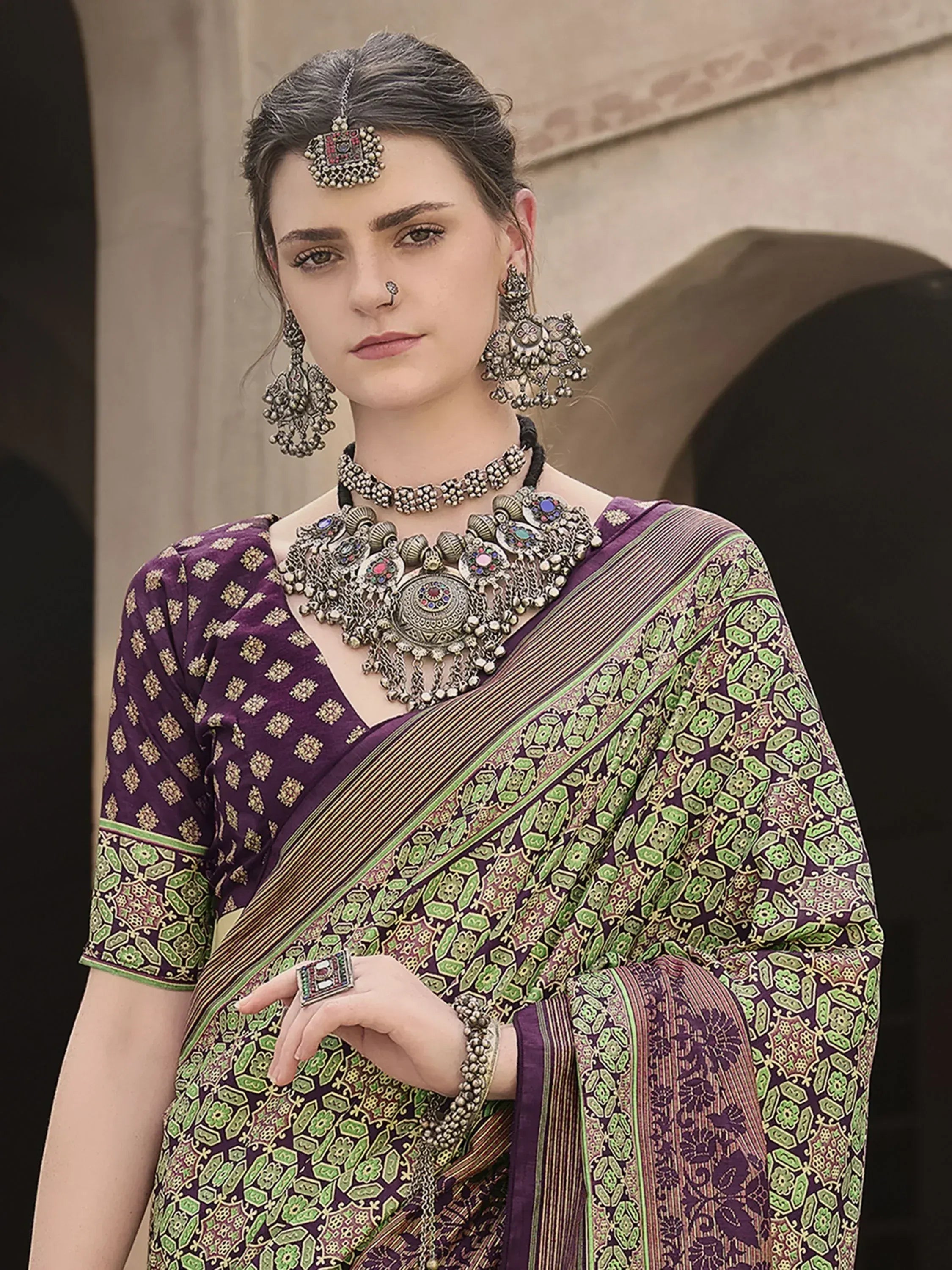 Purple and green printed saree with ethnic jewelry, traditional Indian attire for festive occasions