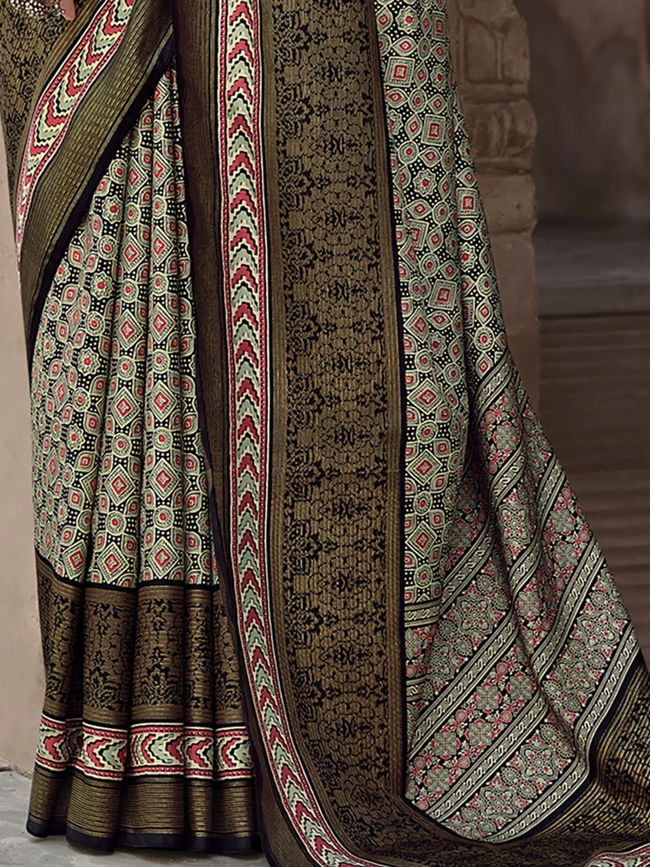 Elegant ethnic saree with intricate geometric and floral patterns in olive, red, and black, perfect for traditional occasions.