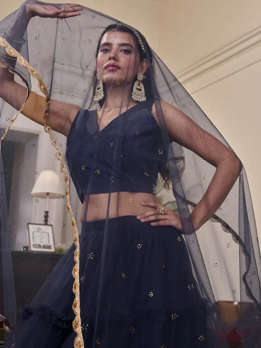 Navy blue lehenga choli with gold embroidery, sheer dupatta, and statement earrings for ethnic wear