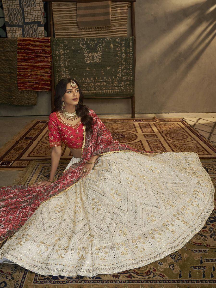 Elegant red and cream embroidered lehenga choli with gold detailing, perfect for Indian ethnic occasions.