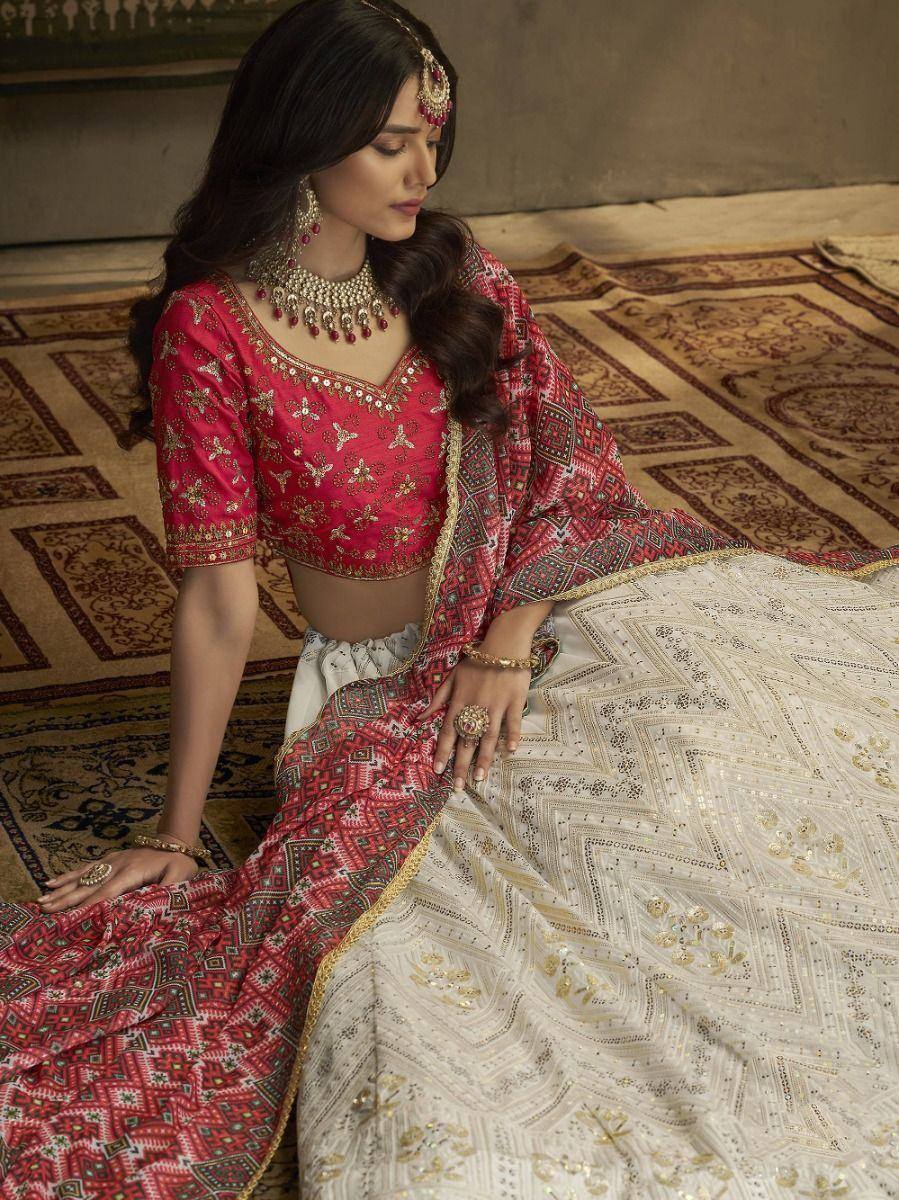 Red and white embroidered lehenga choli with gold detailing, traditional Indian ethnic wear for weddings