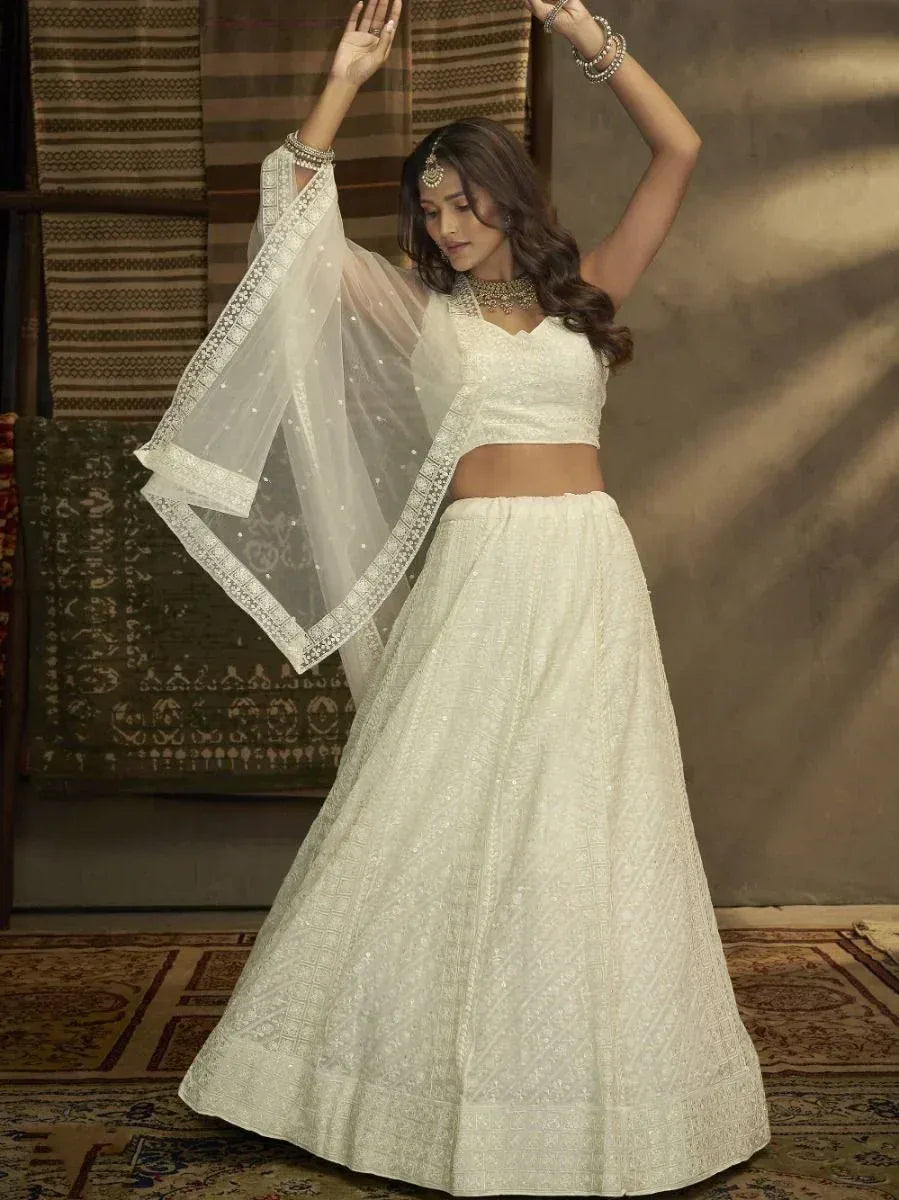 Elegant white embroidered lehenga choli with sheer dupatta, perfect for Indian ethnic occasions