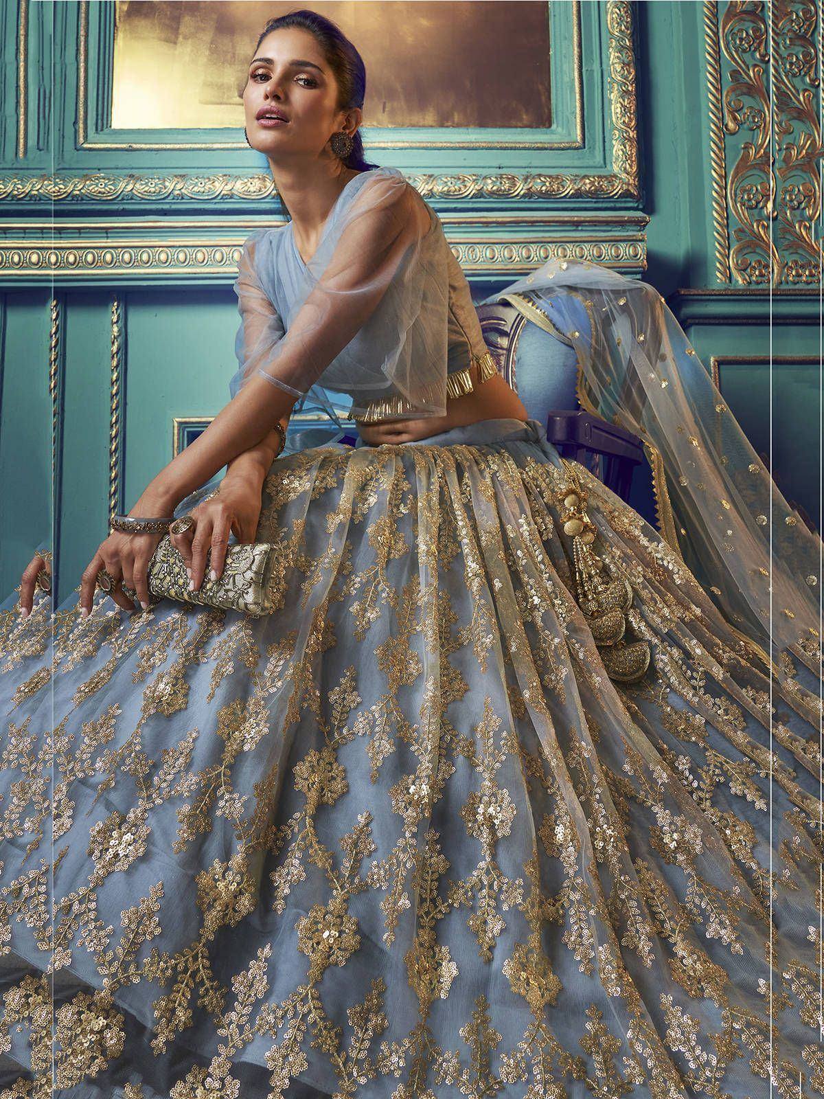 Elegant blue lehenga choli with gold embroidery, perfect for Indian weddings and festive occasions.
