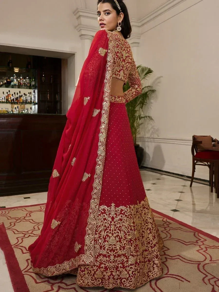 Red designer lehenga choli with gold embroidery, perfect for Indian ethnic wear occasions.