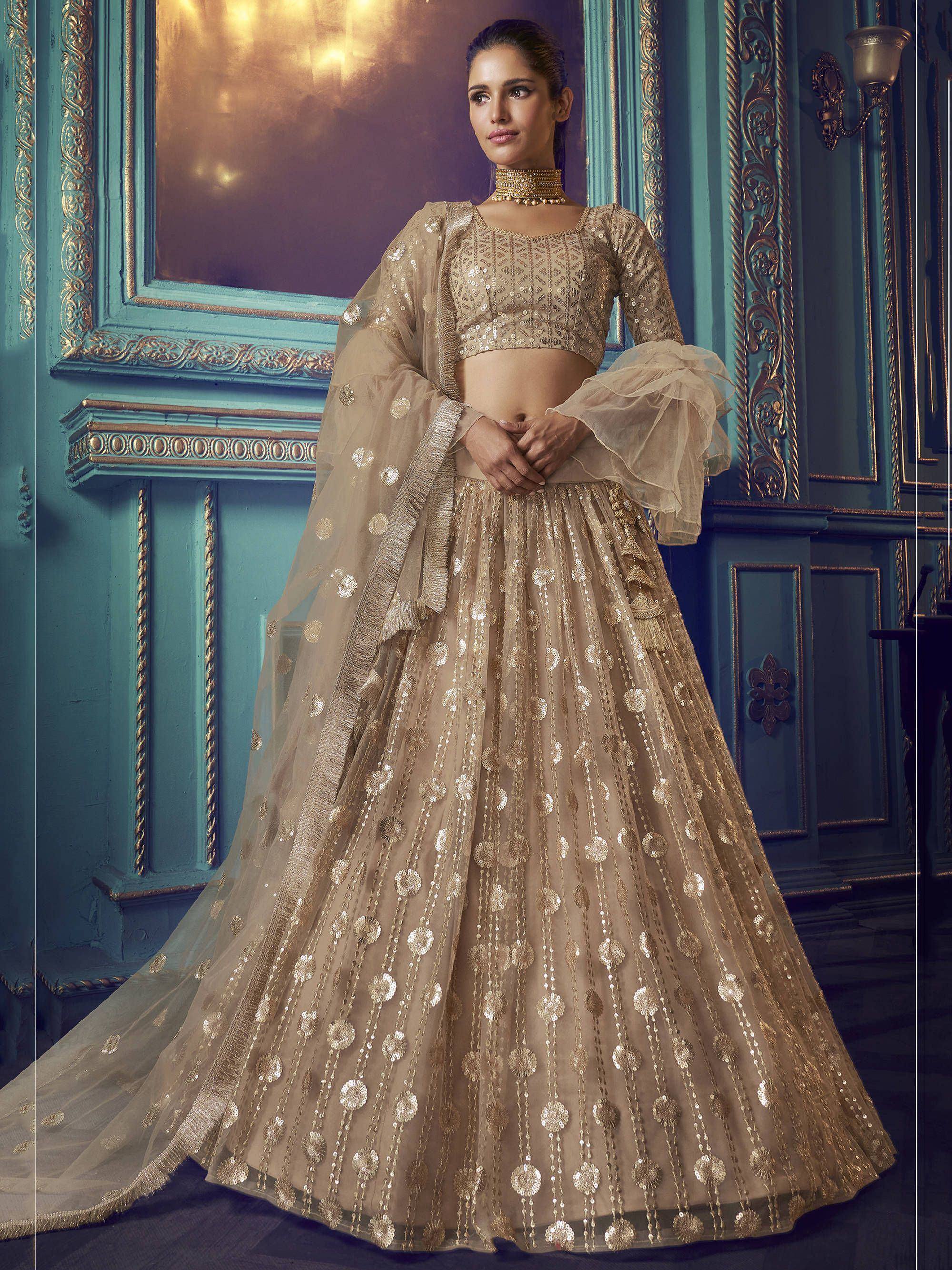 Elegant beige sequin lehenga choli with sheer dupatta, perfect for Indian weddings and festive occasions.