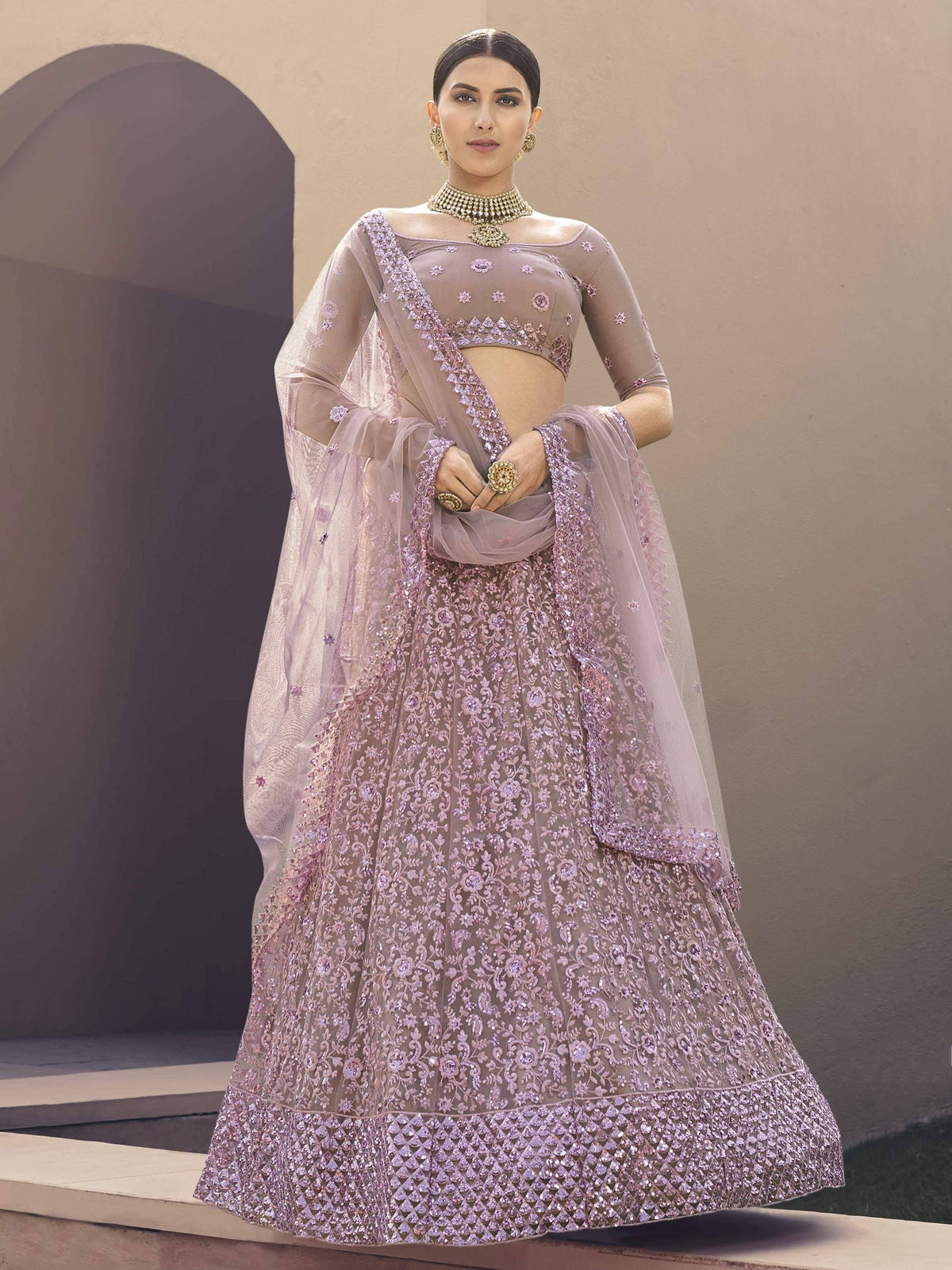 Elegant lavender designer lehenga choli with intricate floral embroidery and sheer dupatta for weddings