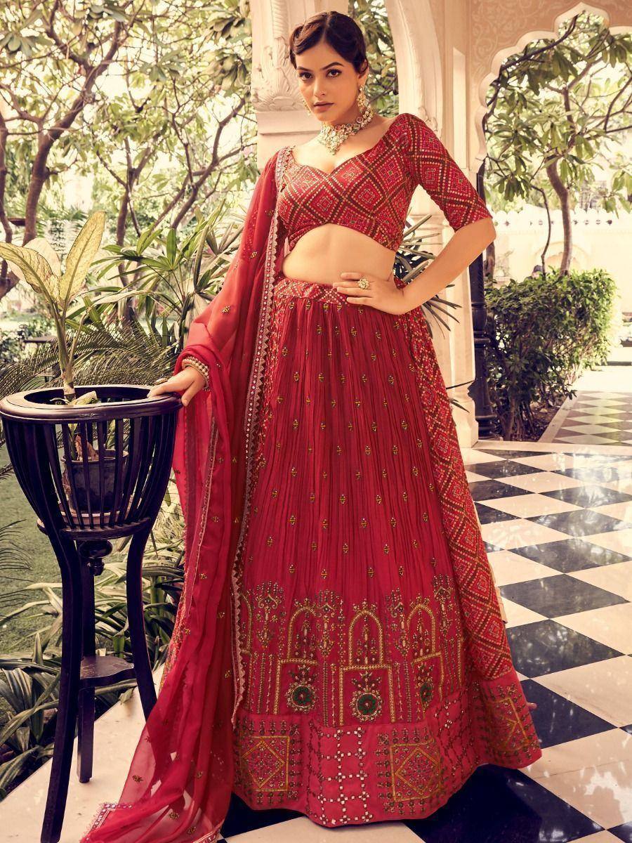 Red embroidered lehenga choli with gold detailing, perfect for Indian weddings and festive occasions