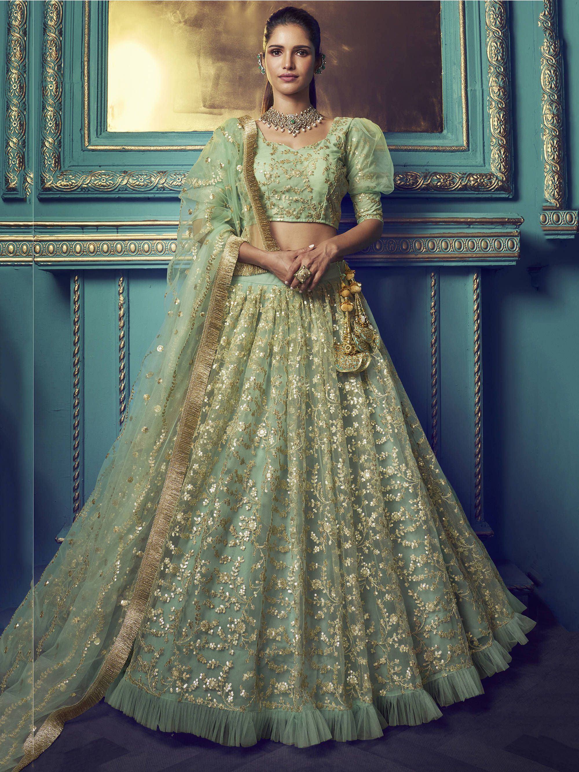 Mint green designer lehenga choli with gold embroidery, perfect for Indian weddings and festive occasions.