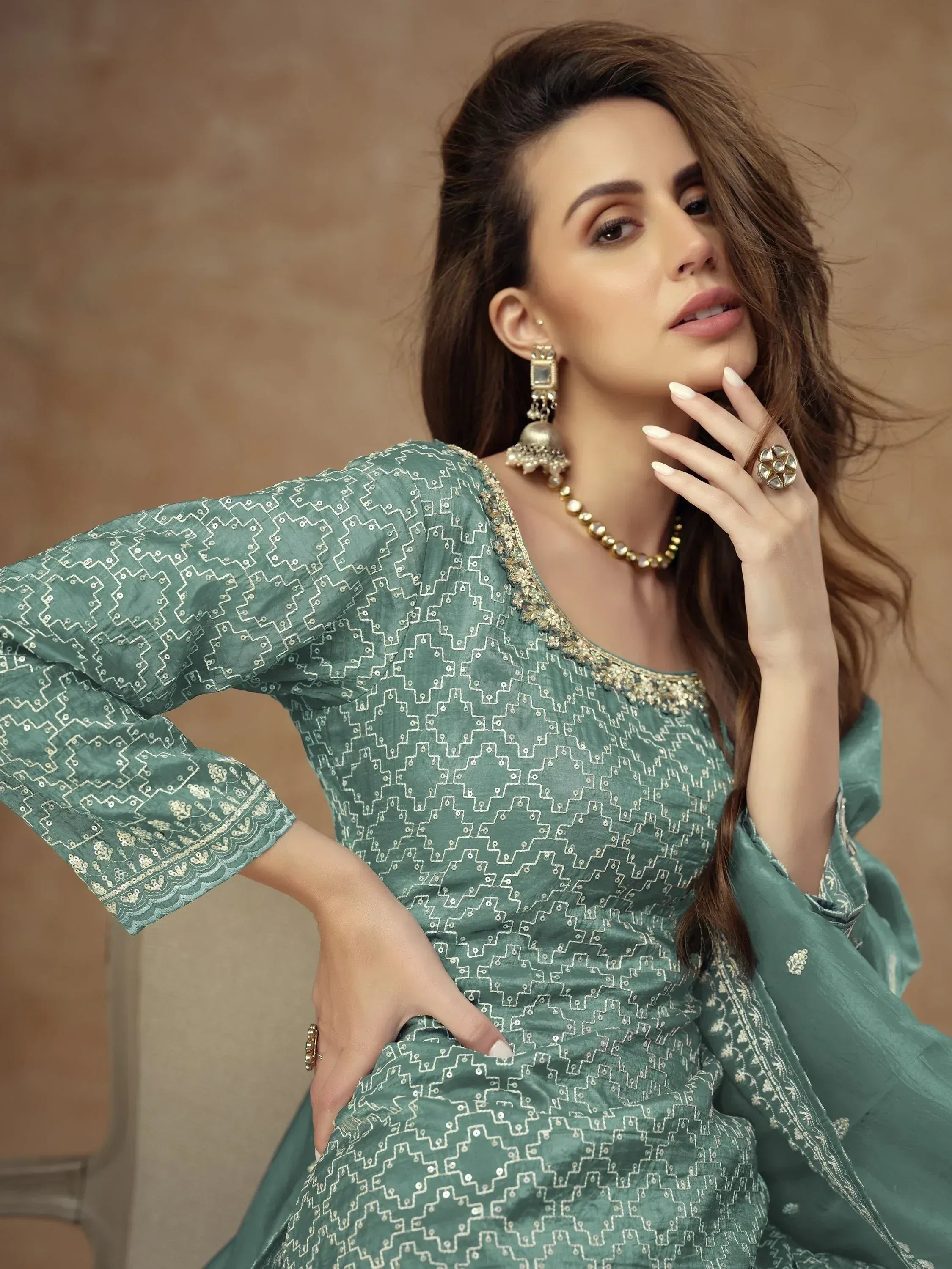 Elegant green ethnic gown with gold embroidery, perfect for Indian occasions and festive wear.
