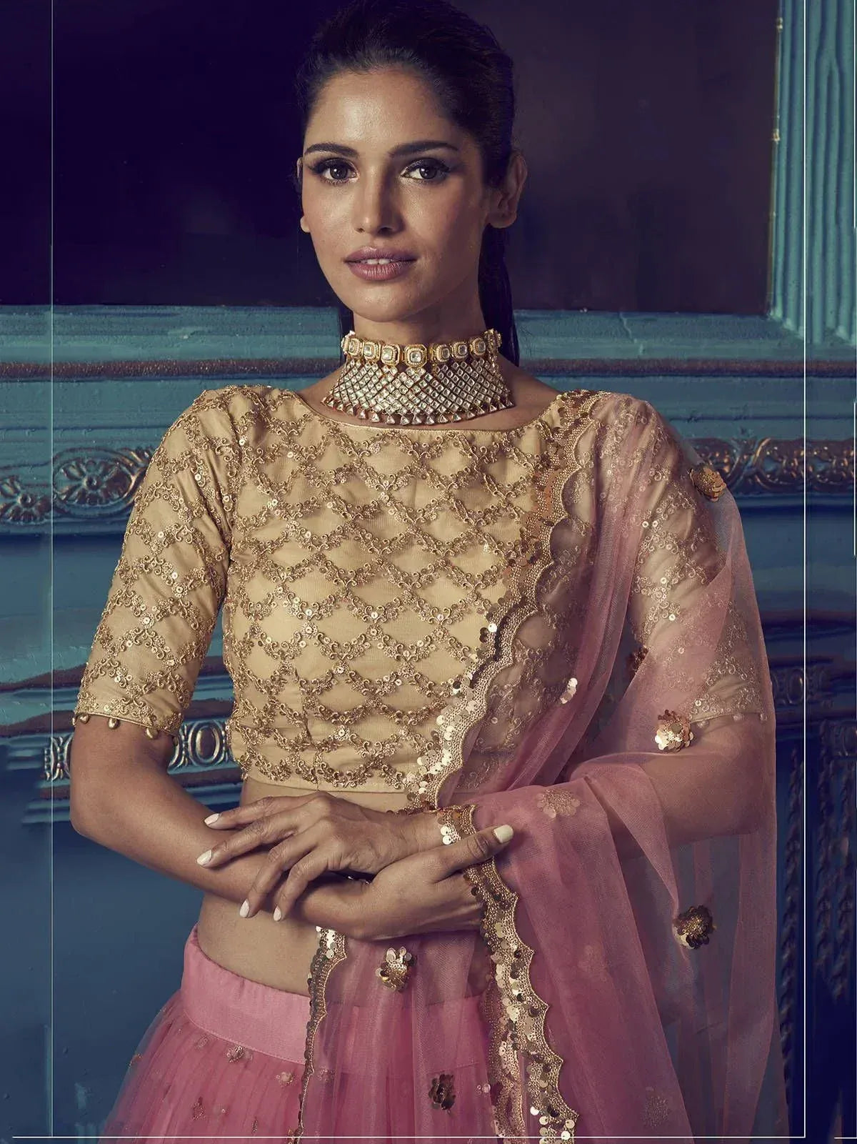 Elegant pink and gold embroidered lehenga choli with sequin work and matching dupatta, perfect for Indian ethnic wear.
