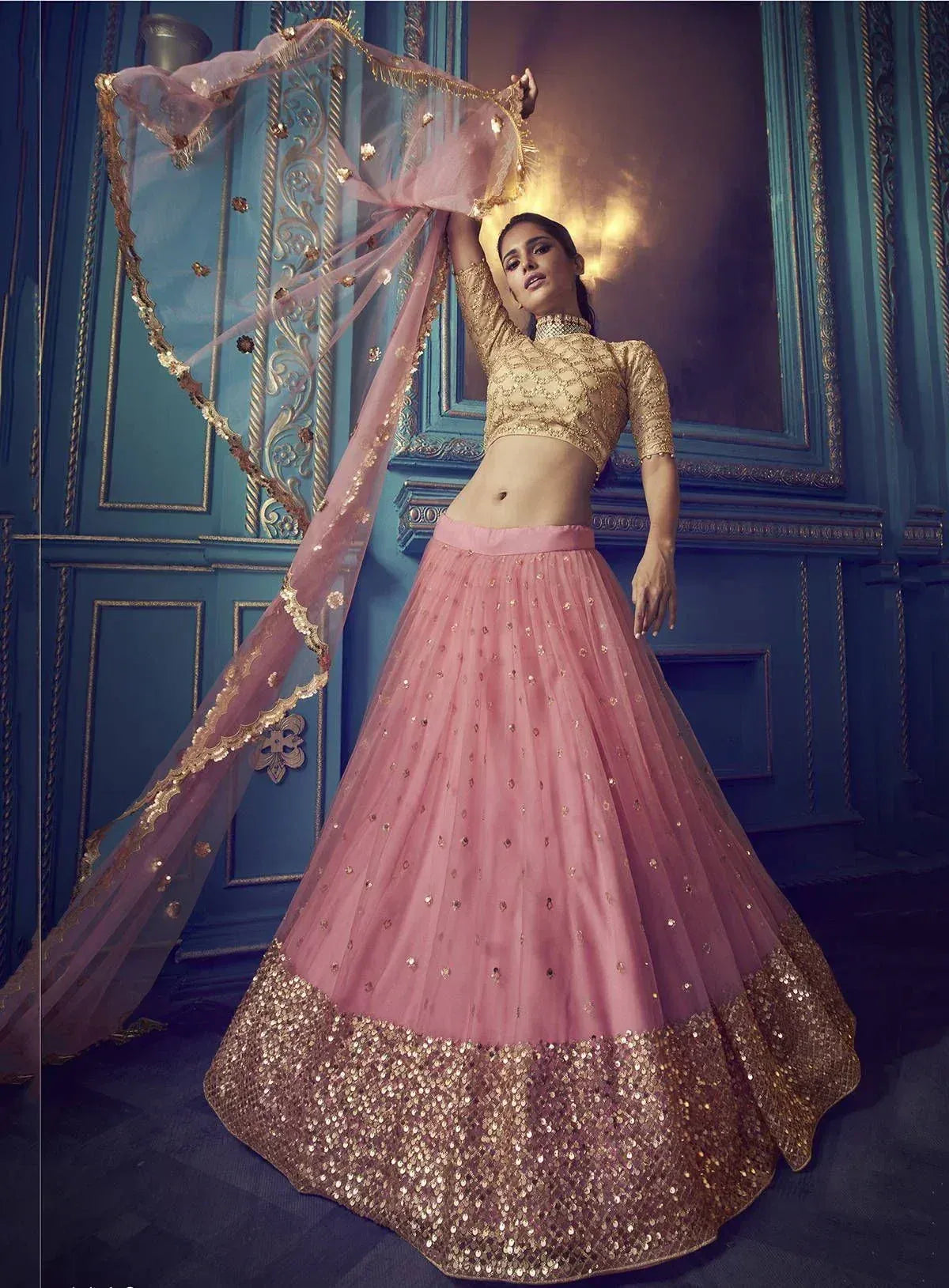 Pink and gold embroidered lehenga choli with sequin border and matching dupatta, perfect for Indian weddings and festive occasions