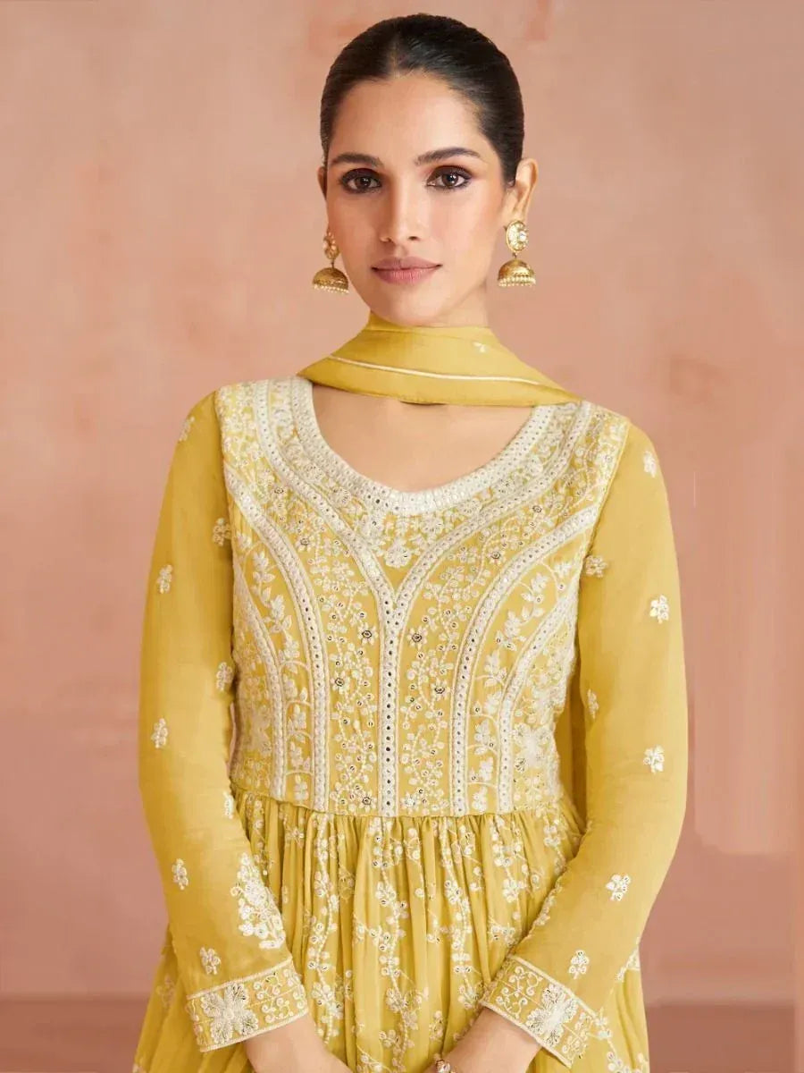 Woman in yellow embroidered salwar kameez with dupatta, traditional Indian ethnic wear