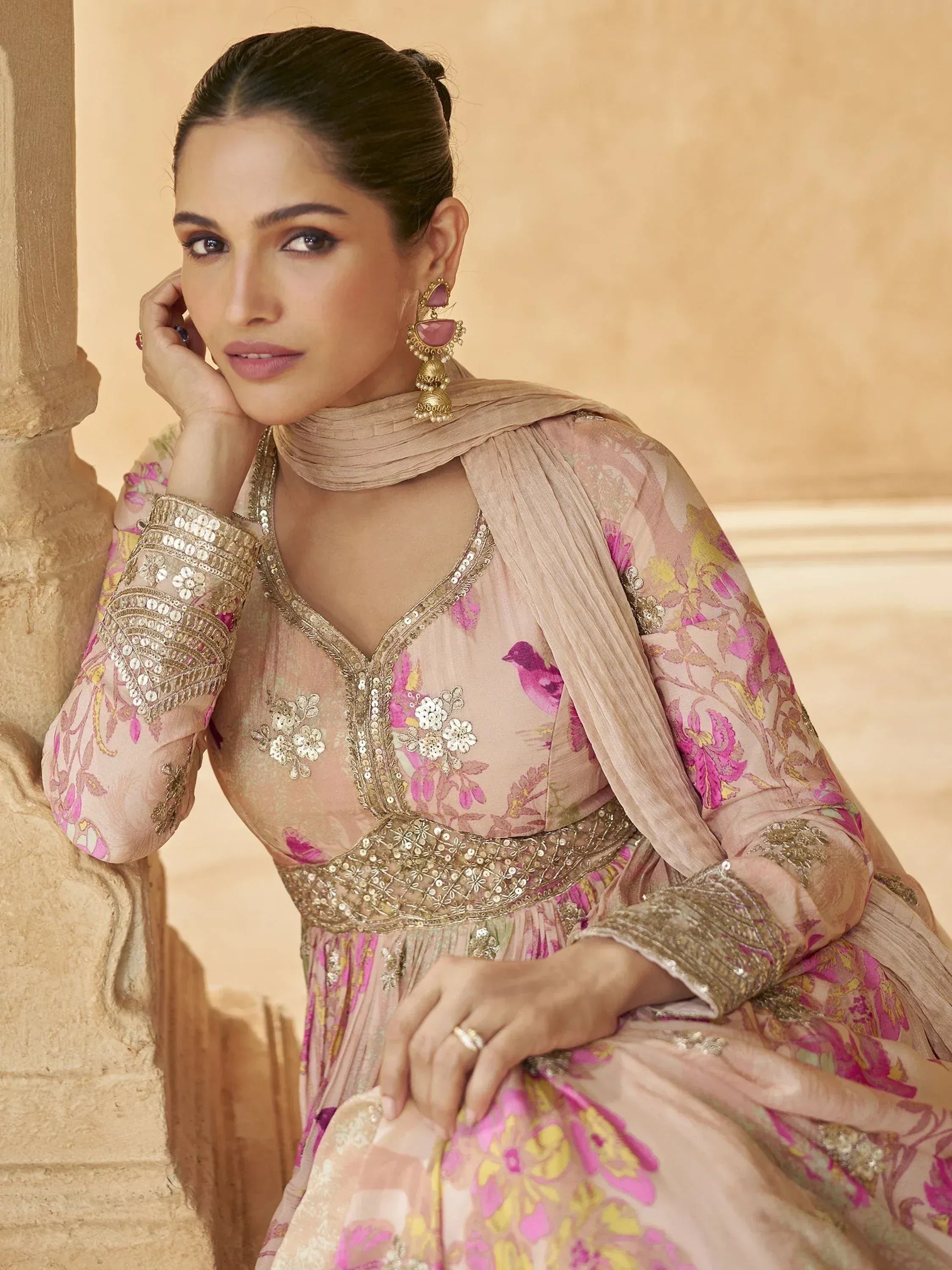 Elegant pink floral ethnic gown with gold embroidery, perfect for Indian weddings and festive occasions.