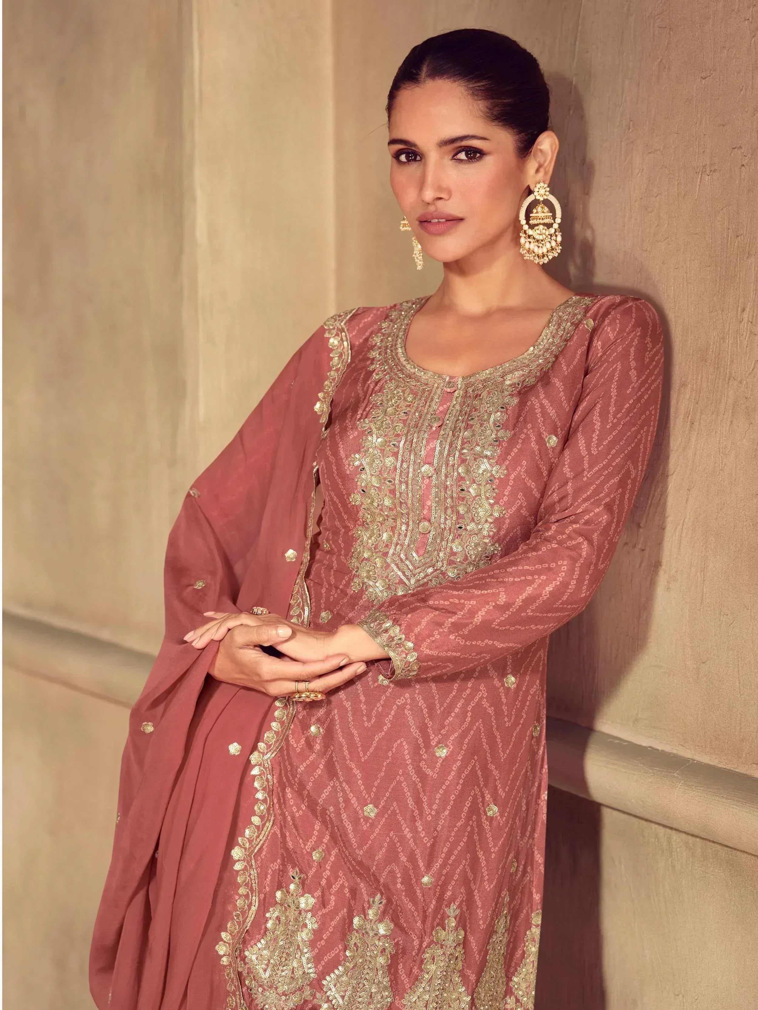 Dusty rose ethnic salwar kameez with gold embroidery and matching dupatta, styled with jhumka earrings