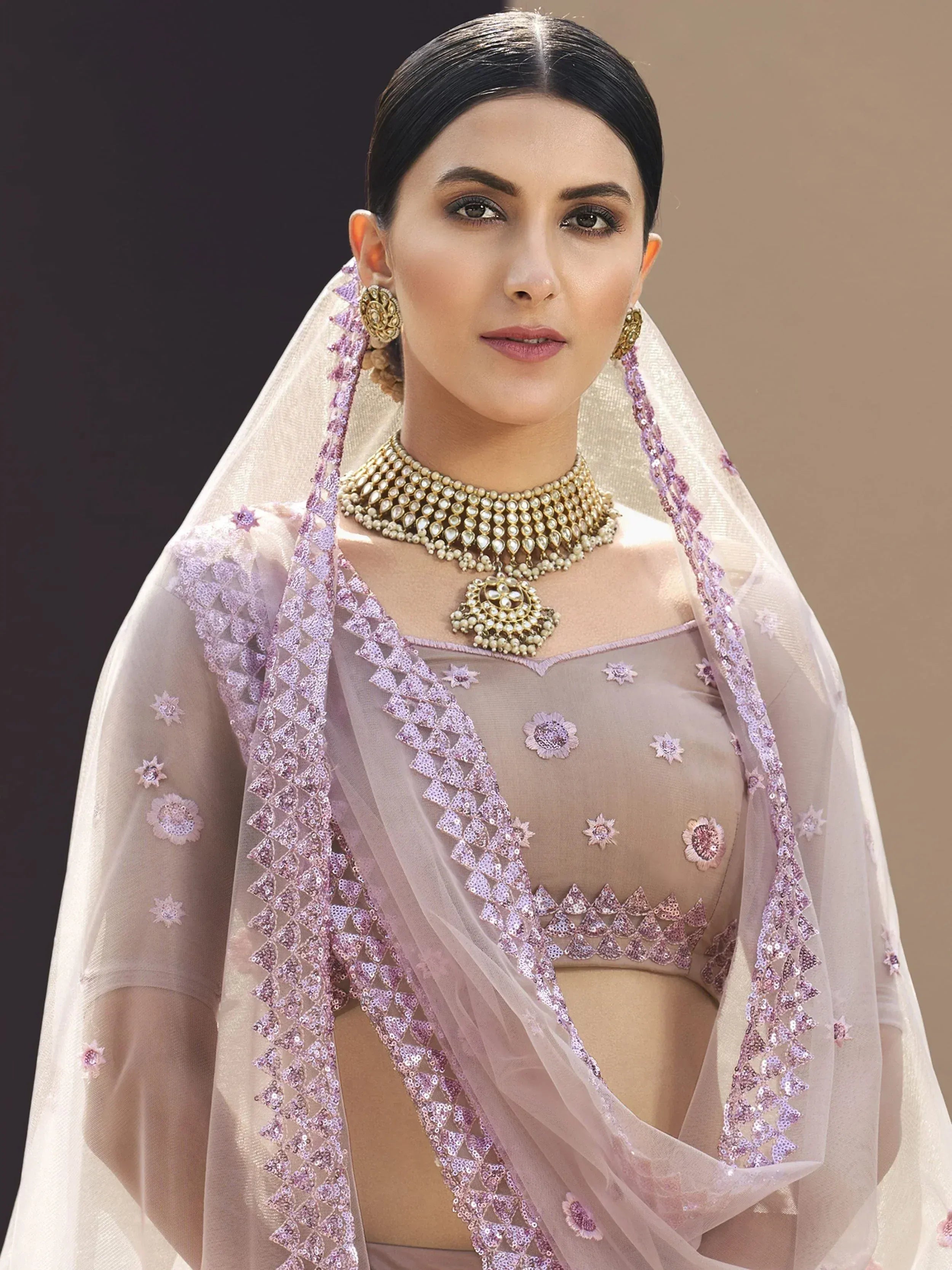 Elegant lavender ethnic blouse with floral embroidery and sheer dupatta, paired with traditional jewelry