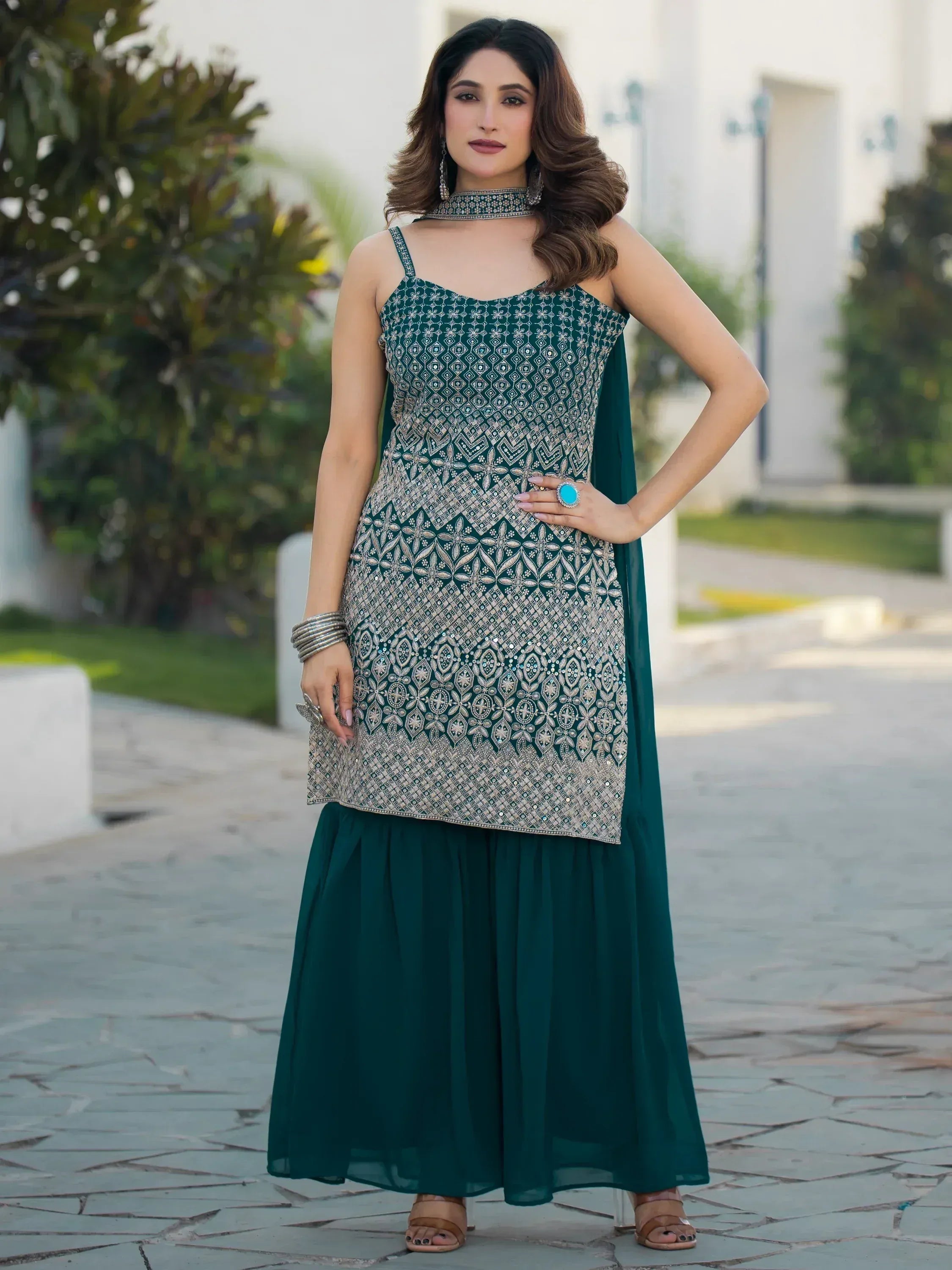 Emerald green embroidered ethnic gown with choker, perfect for Indian festive wear and designer occasions.