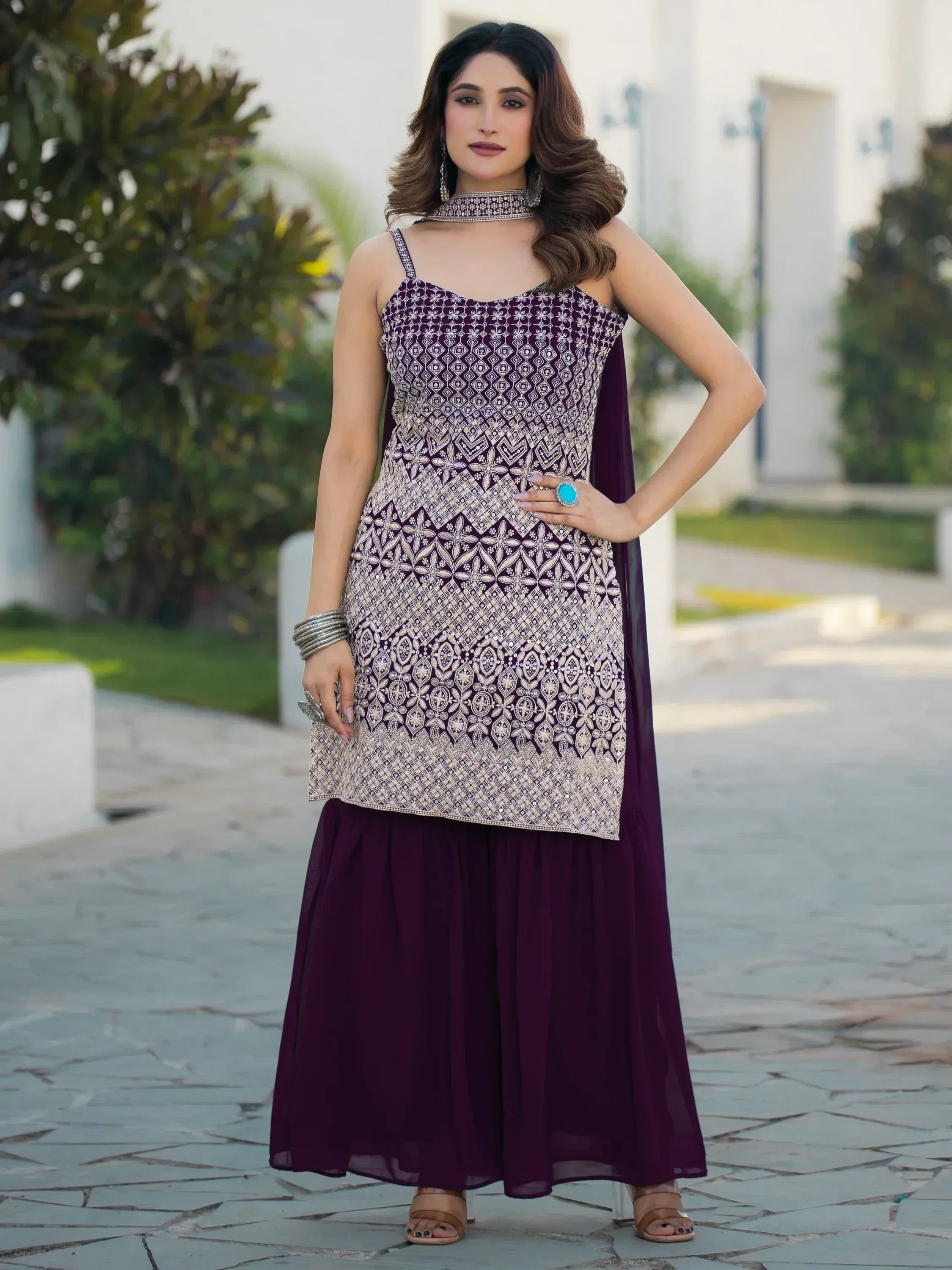 Elegant purple ethnic gown with intricate silver embroidery, perfect for Indian festive occasions.