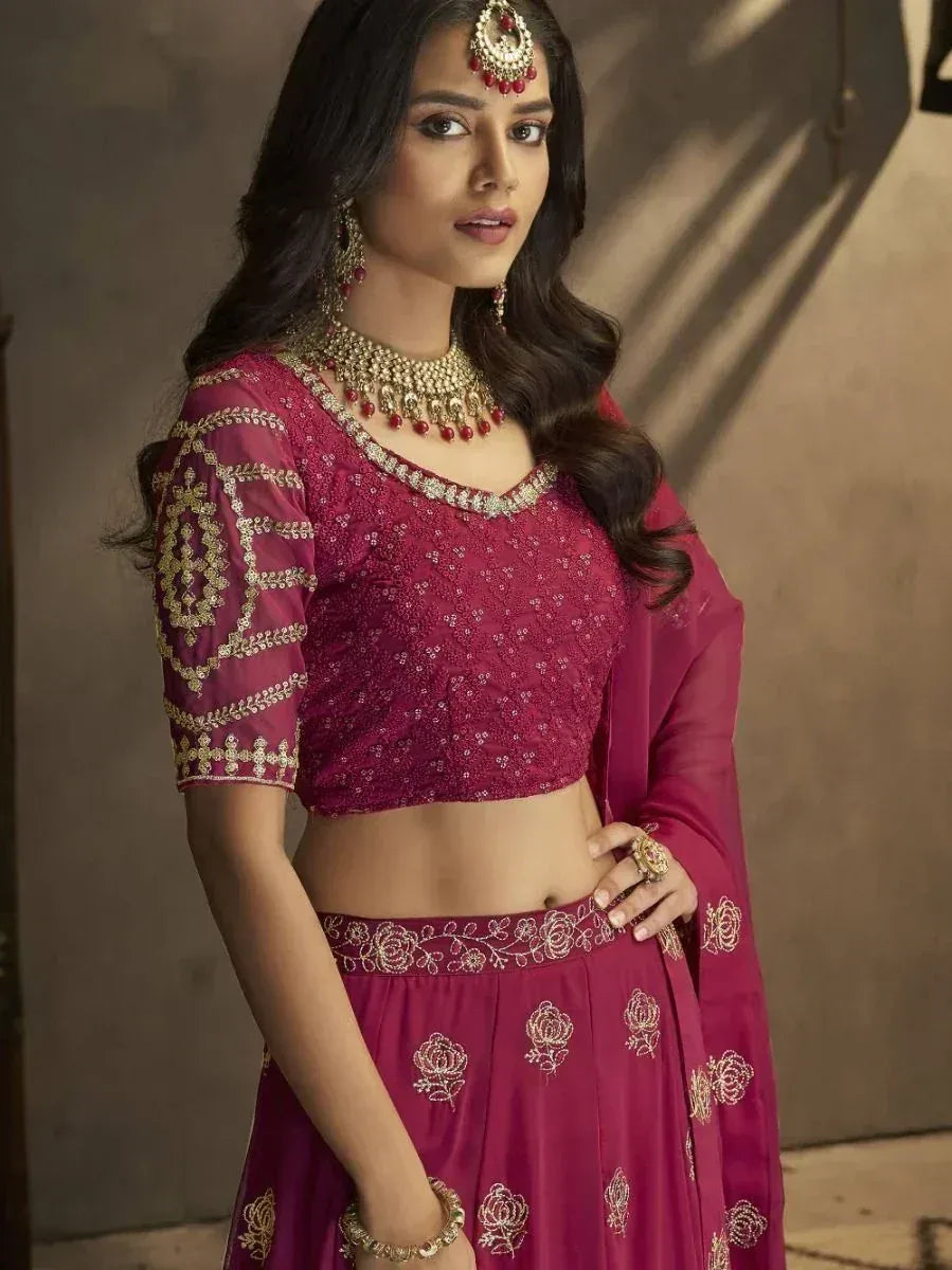 Maroon designer lehenga choli with gold embroidery and matching jewelry for Indian ethnic wear