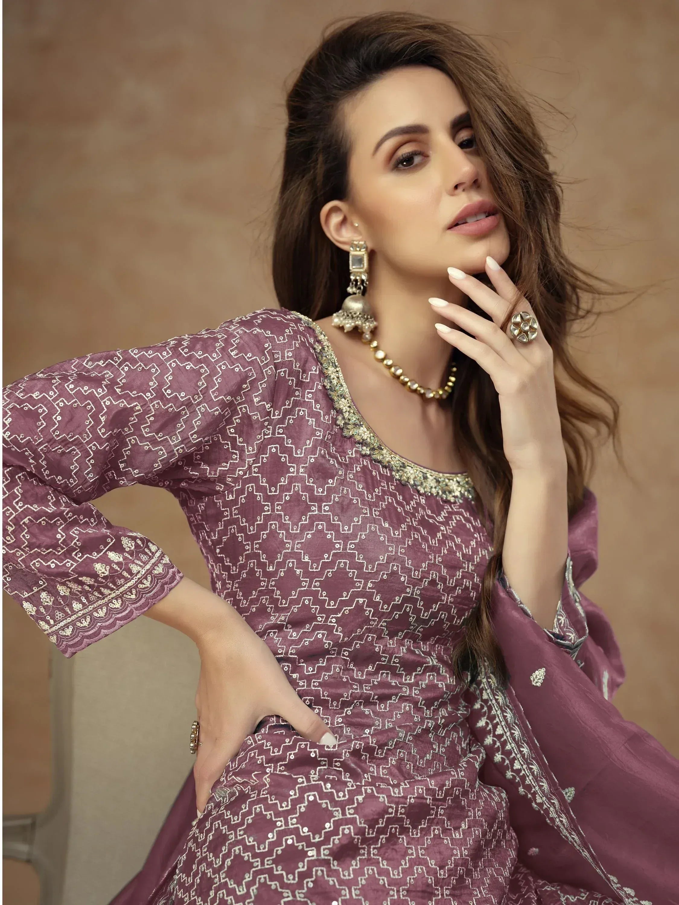 Elegant purple ethnic gown with geometric embroidery, perfect for Indian festive occasions and weddings.