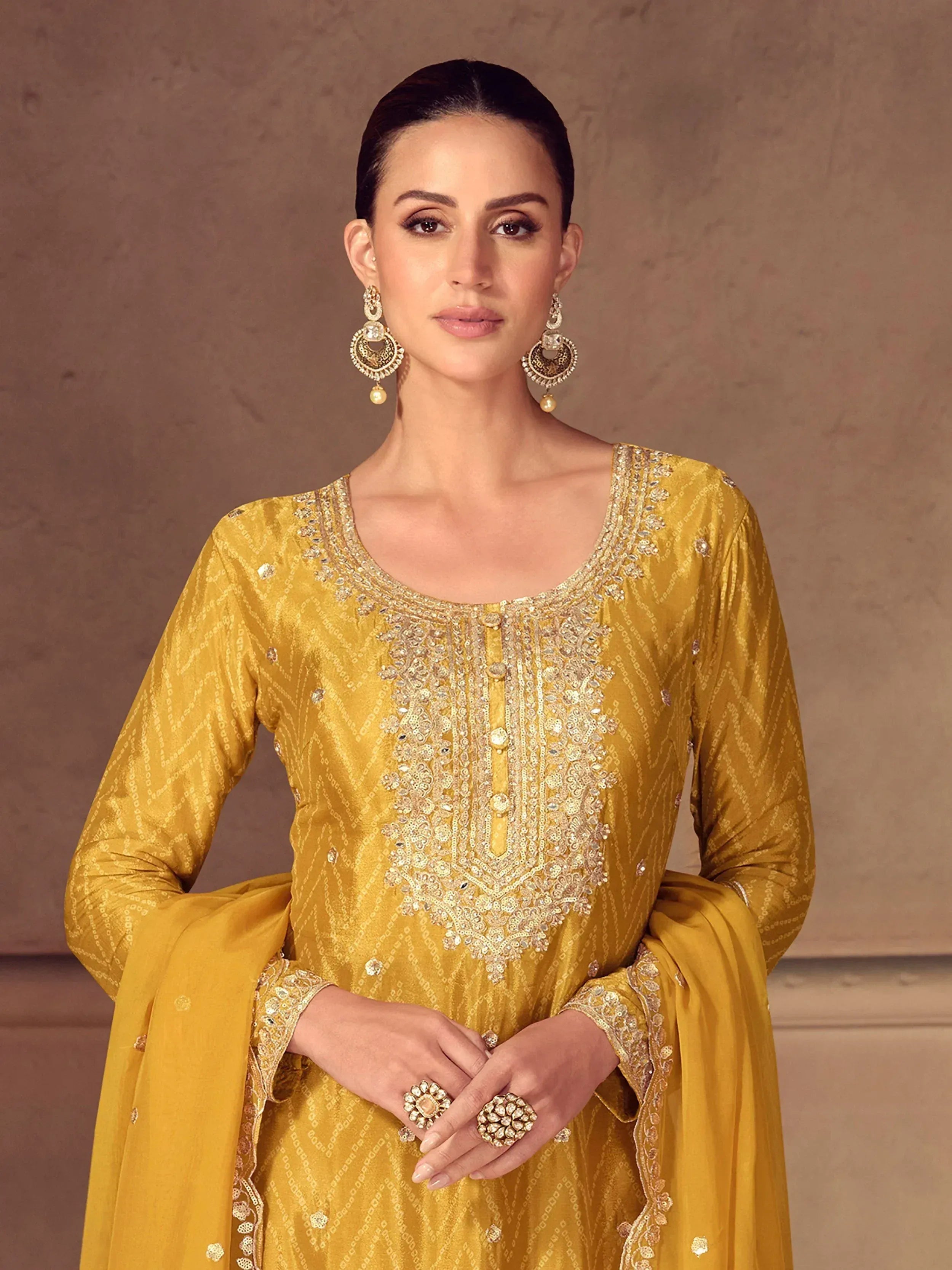 Elegant mustard yellow embroidered salwar kameez with gold detailing and matching jewelry