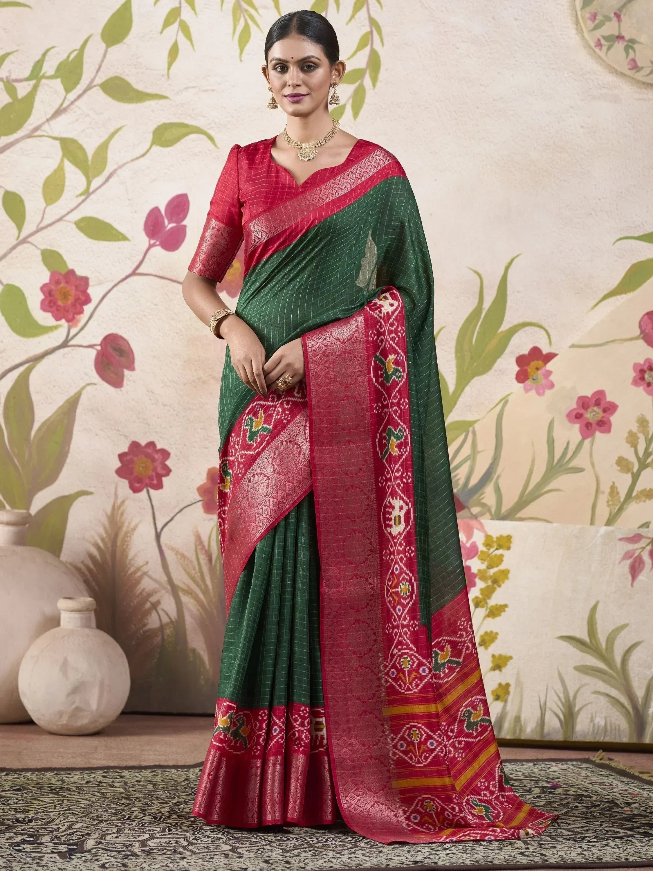 Green and red ethnic saree with intricate woven patterns and traditional motifs, perfect for Indian occasions