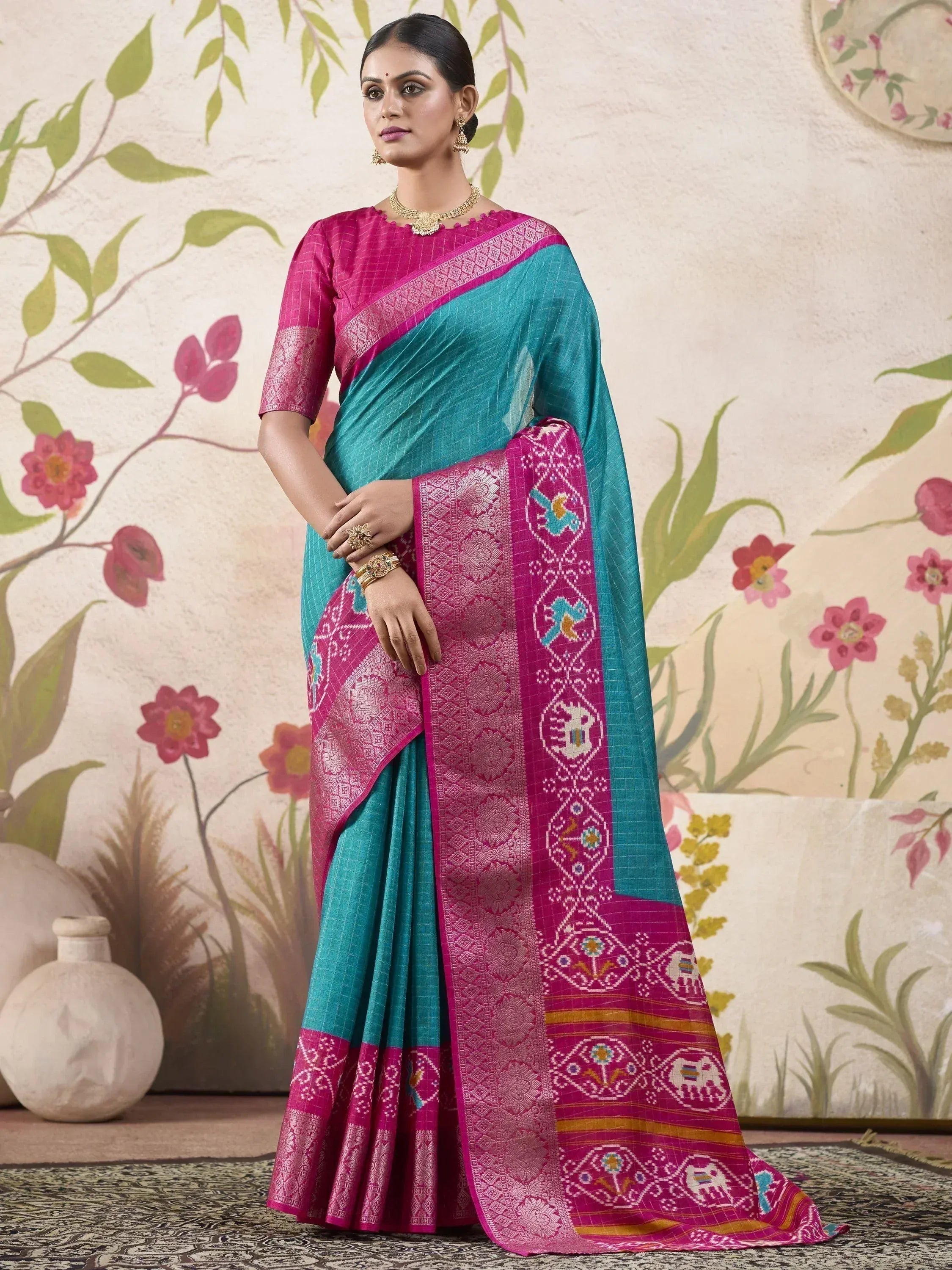 Teal and magenta ethnic saree with intricate bird and elephant motifs, perfect for Indian occasions