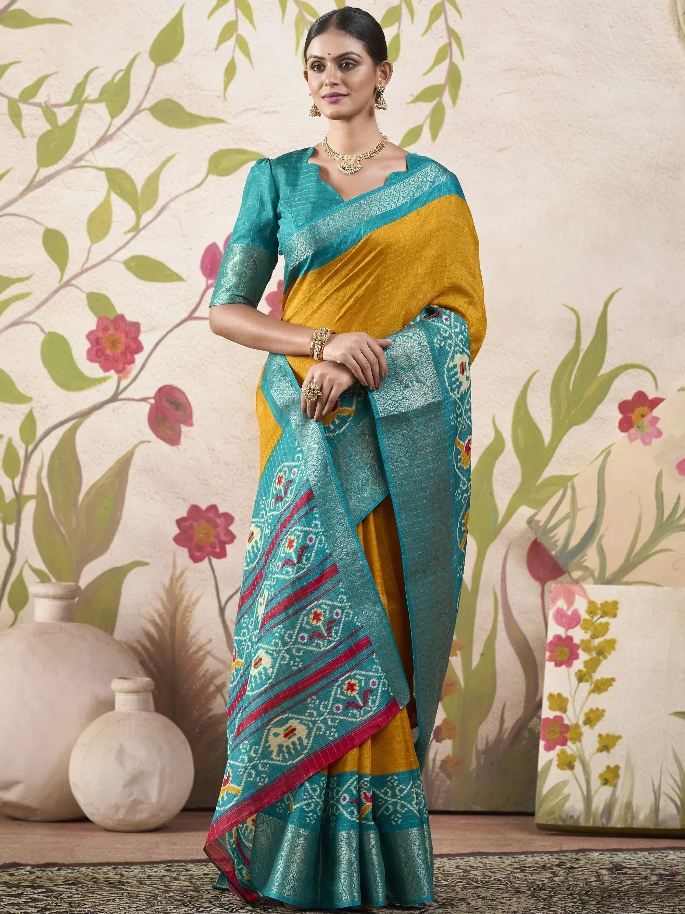 Teal and mustard yellow ethnic saree with embroidered border, perfect for Indian occasions