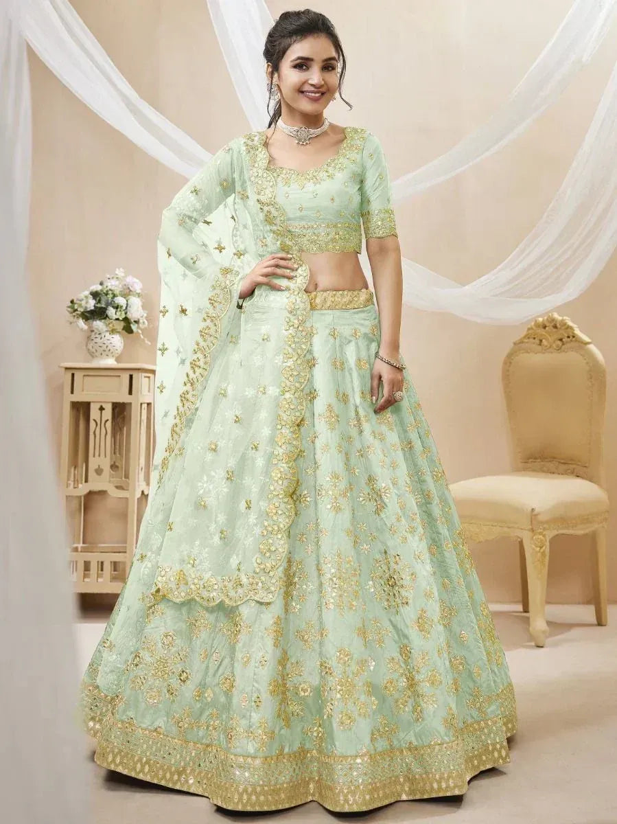 Mint green designer lehenga choli with gold embroidery, perfect for weddings and festive occasions