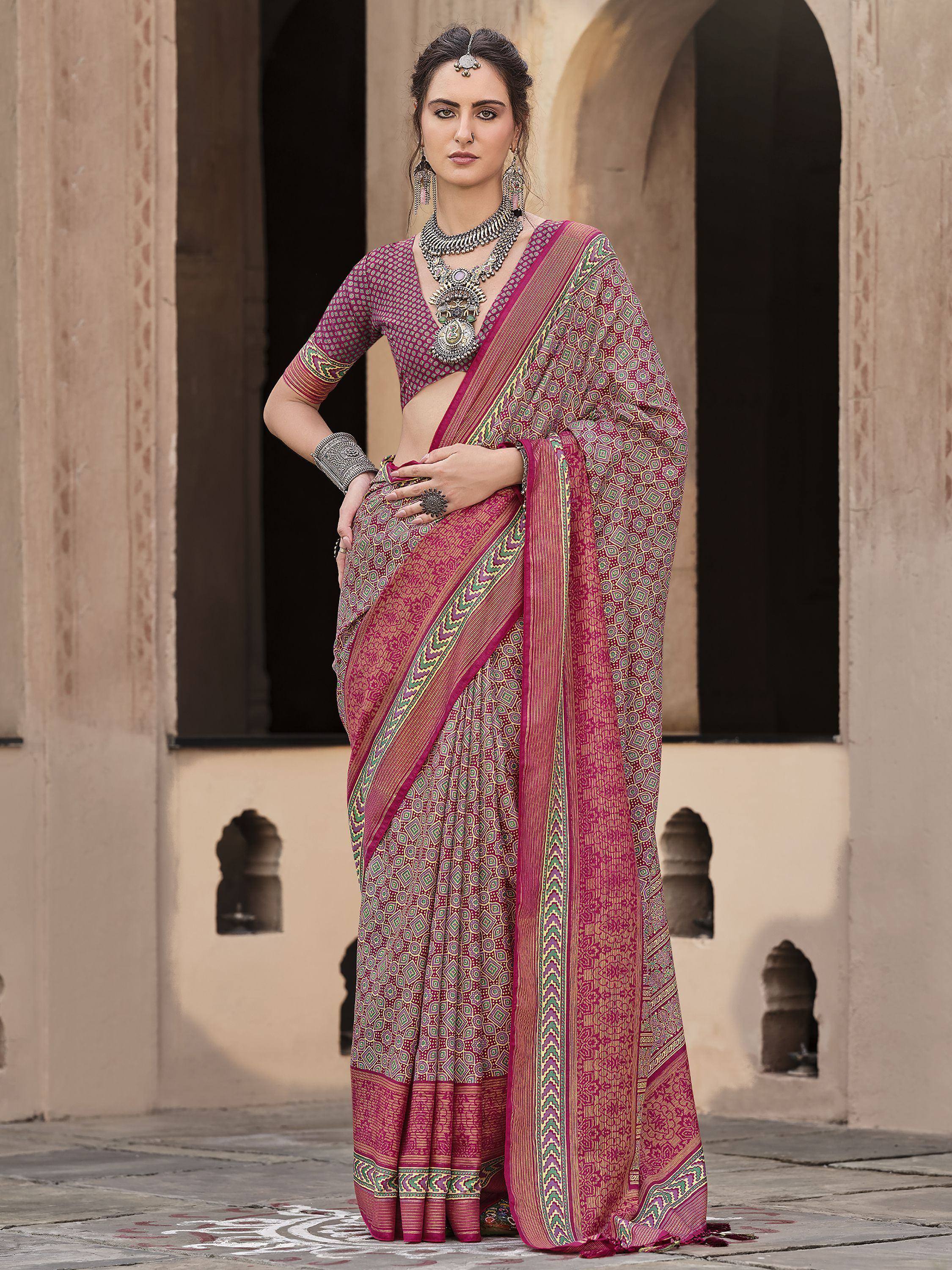 Woman in maroon printed saree with ethnic jewelry, traditional Indian attire for festive occasions