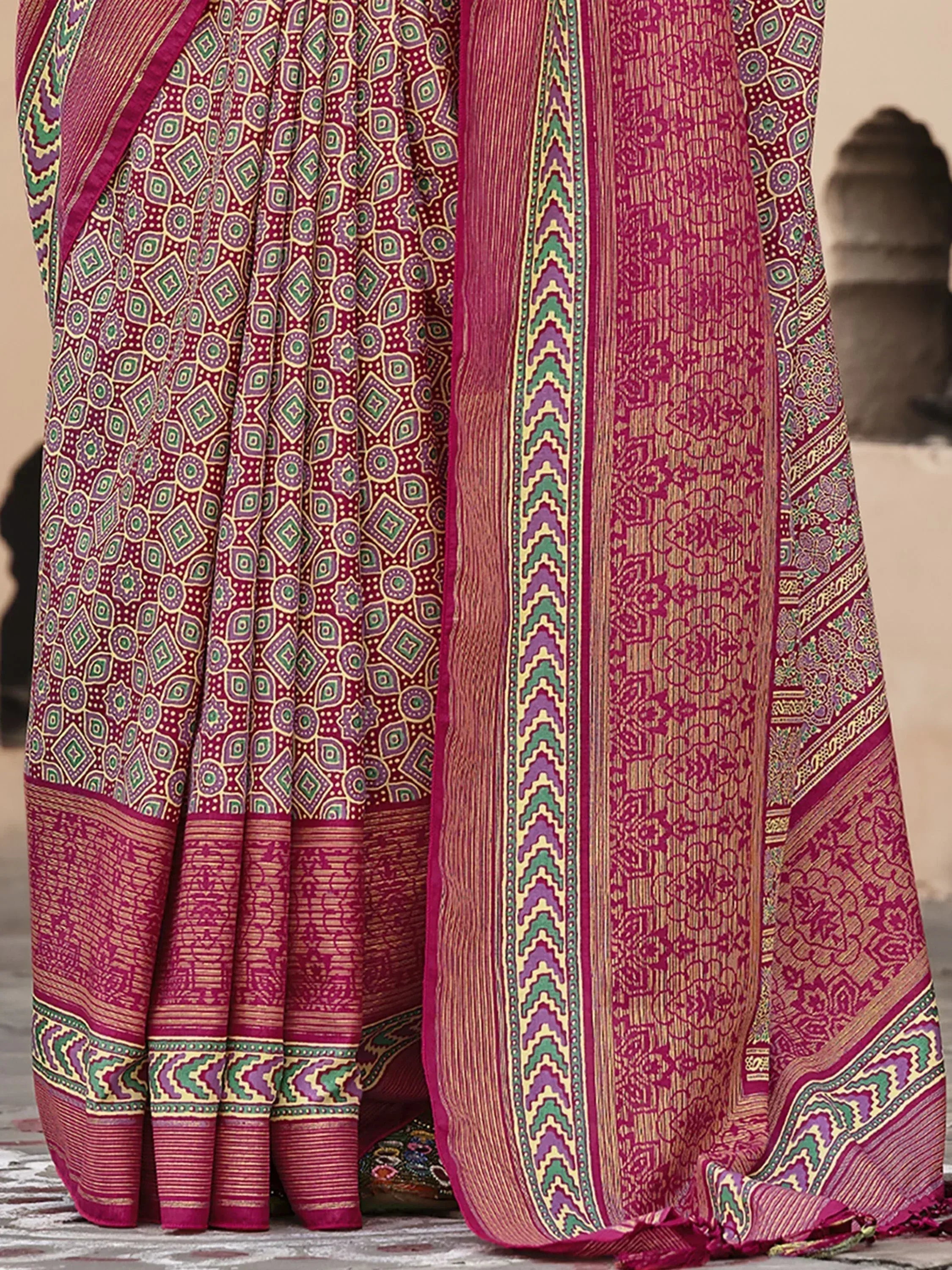 Rich maroon saree with intricate geometric and floral patterns, vibrant border, traditional Indian ethnic wear