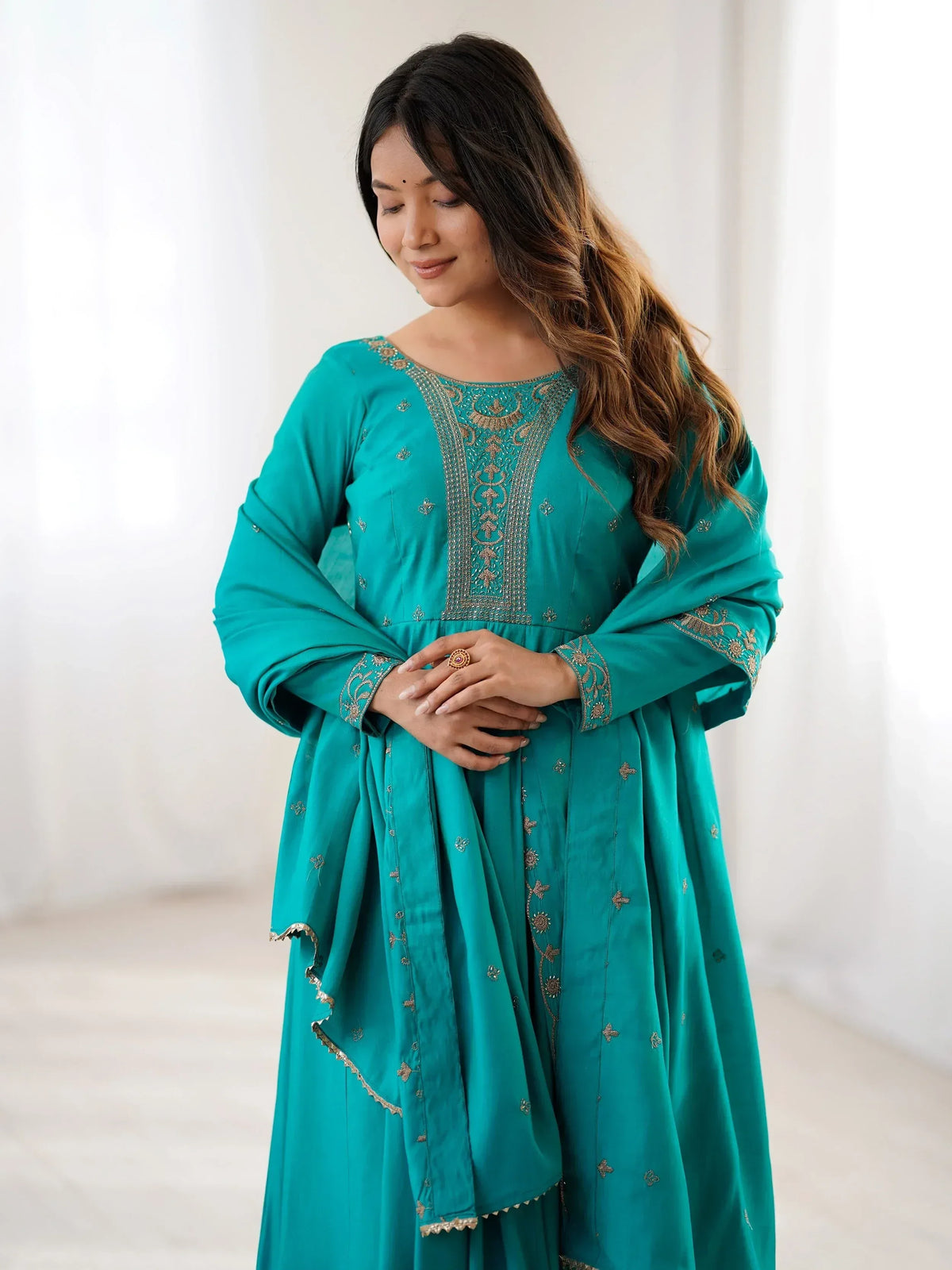 Teal ethnic gown with gold embroidery, perfect for Indian festive occasions