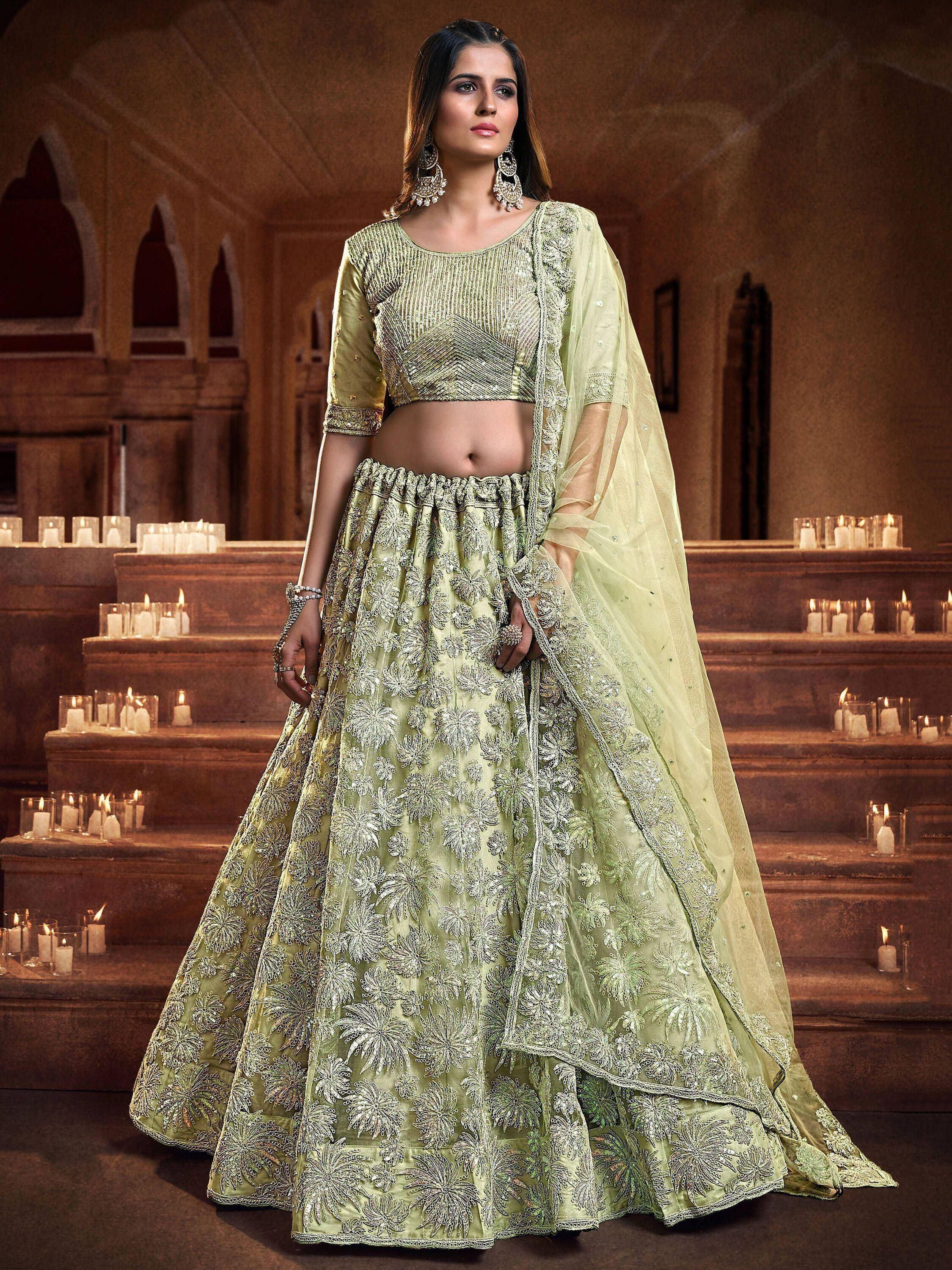 Light green designer lehenga choli with silver floral embroidery, perfect for Indian weddings and festive occasions.