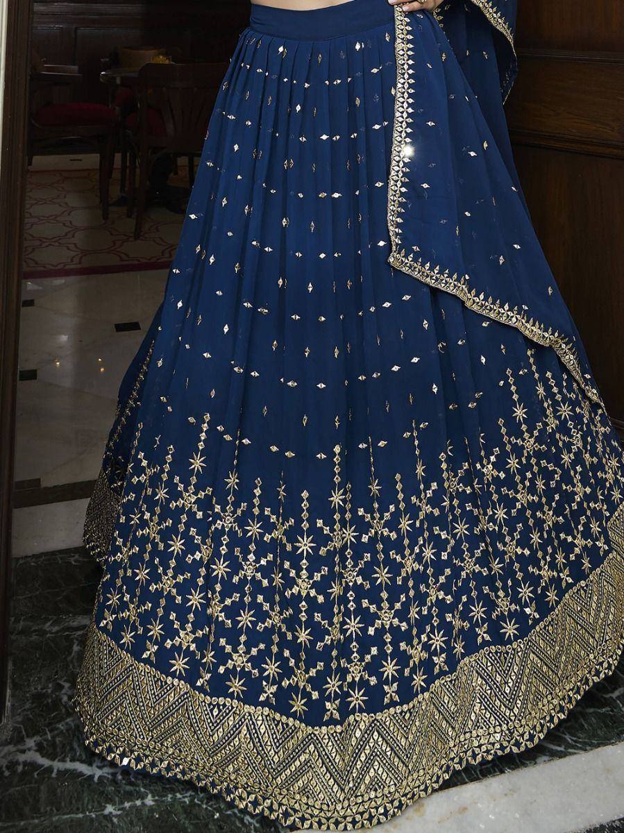 Navy blue lehenga with gold embroidery and mirror work, ethnic Indian wear for weddings