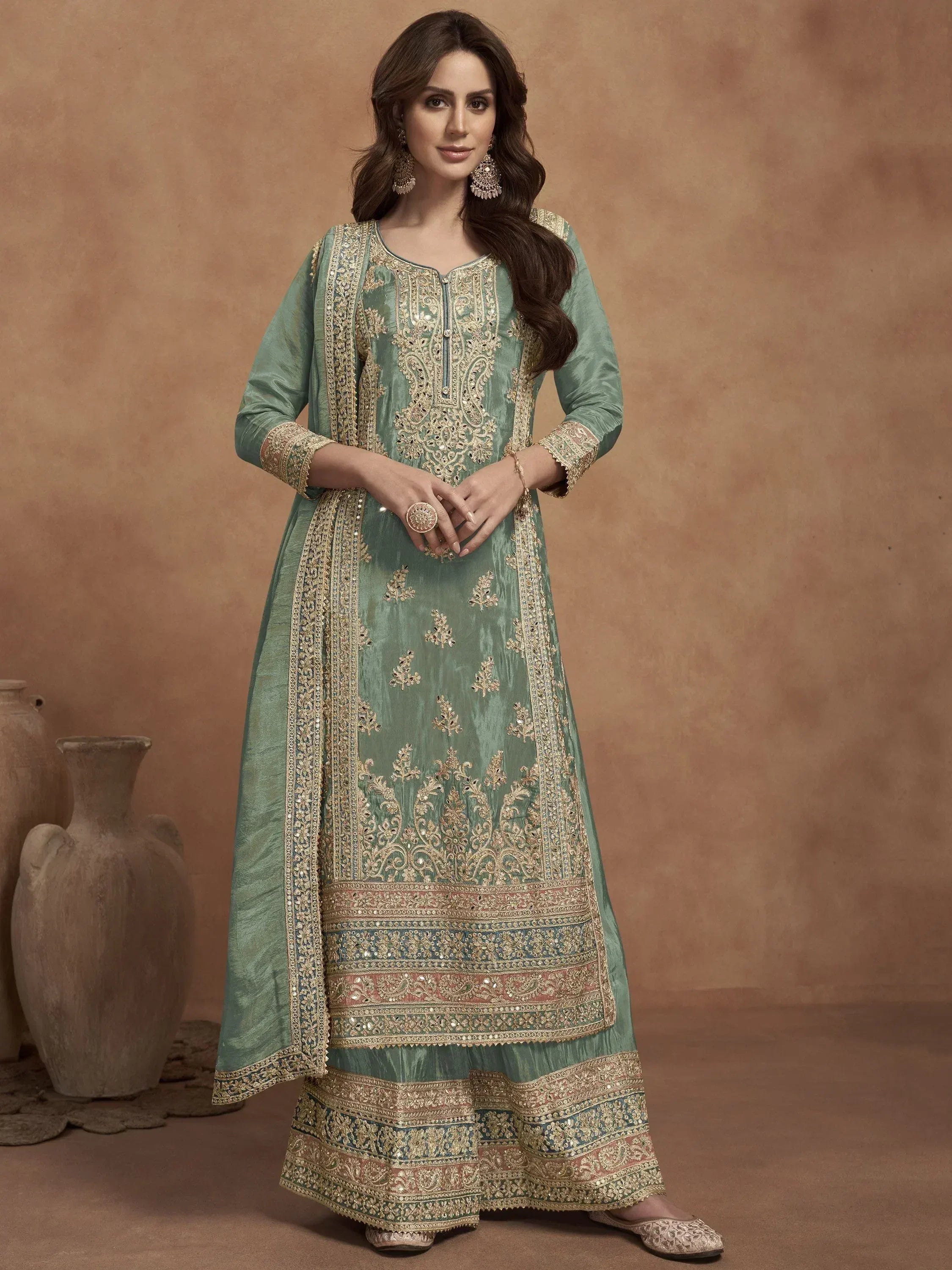 Elegant green embroidered salwar kameez with gold detailing, perfect for ethnic occasions