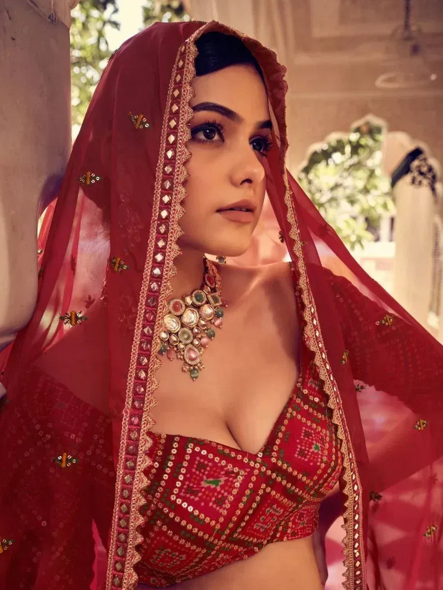 Red embroidered lehenga choli with dupatta and statement jewelry for Indian ethnic wear