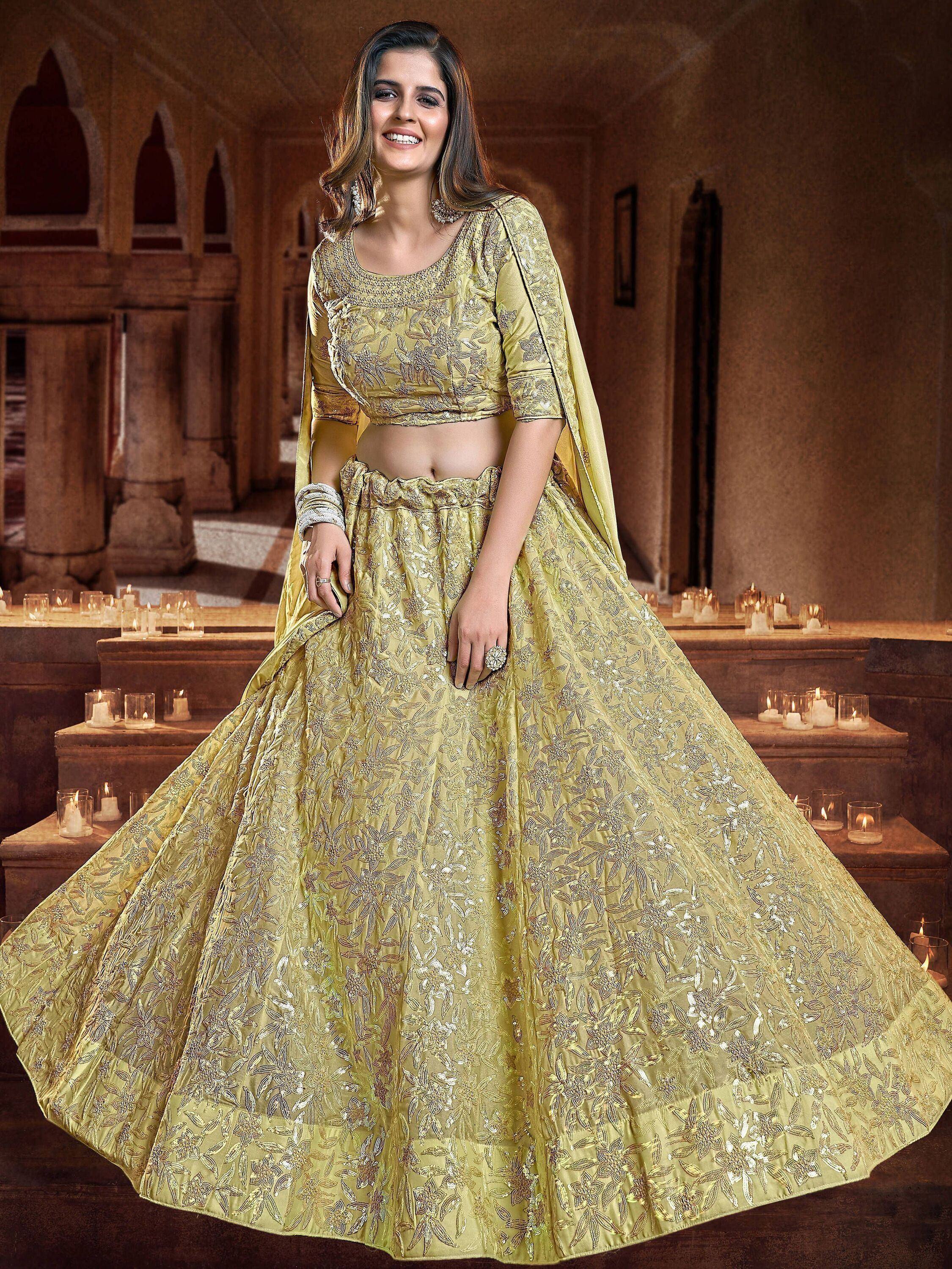 Elegant gold embroidered lehenga choli with floral motifs, perfect for Indian weddings and festive occasions.