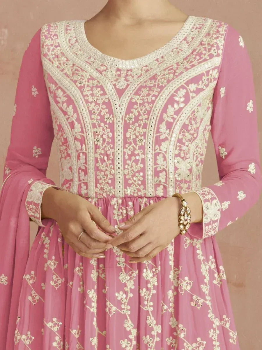 Pink embroidered ethnic gown with floral patterns and delicate white threadwork