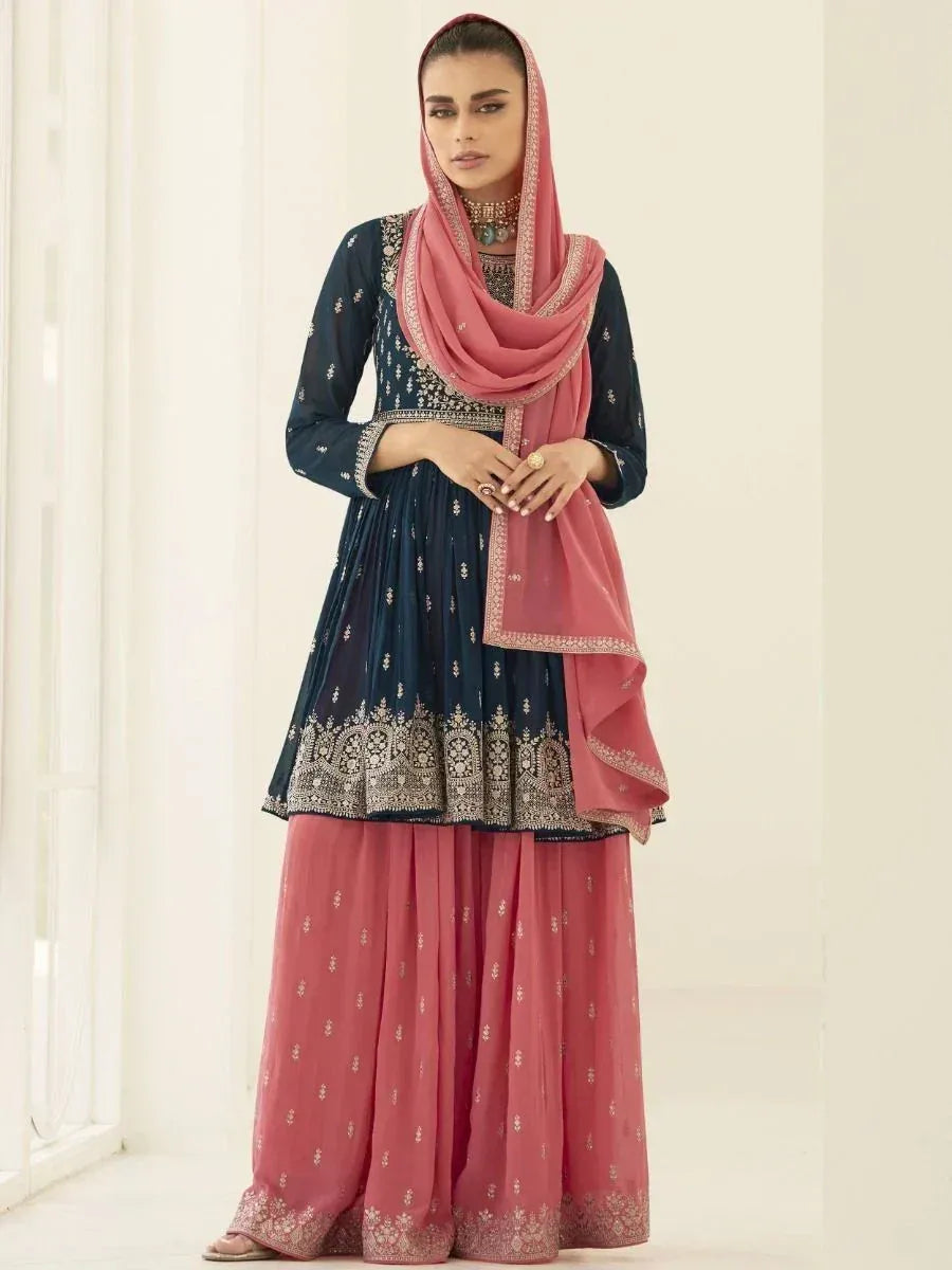 Woman wearing navy blue and pink embroidered ethnic sharara suit with dupatta