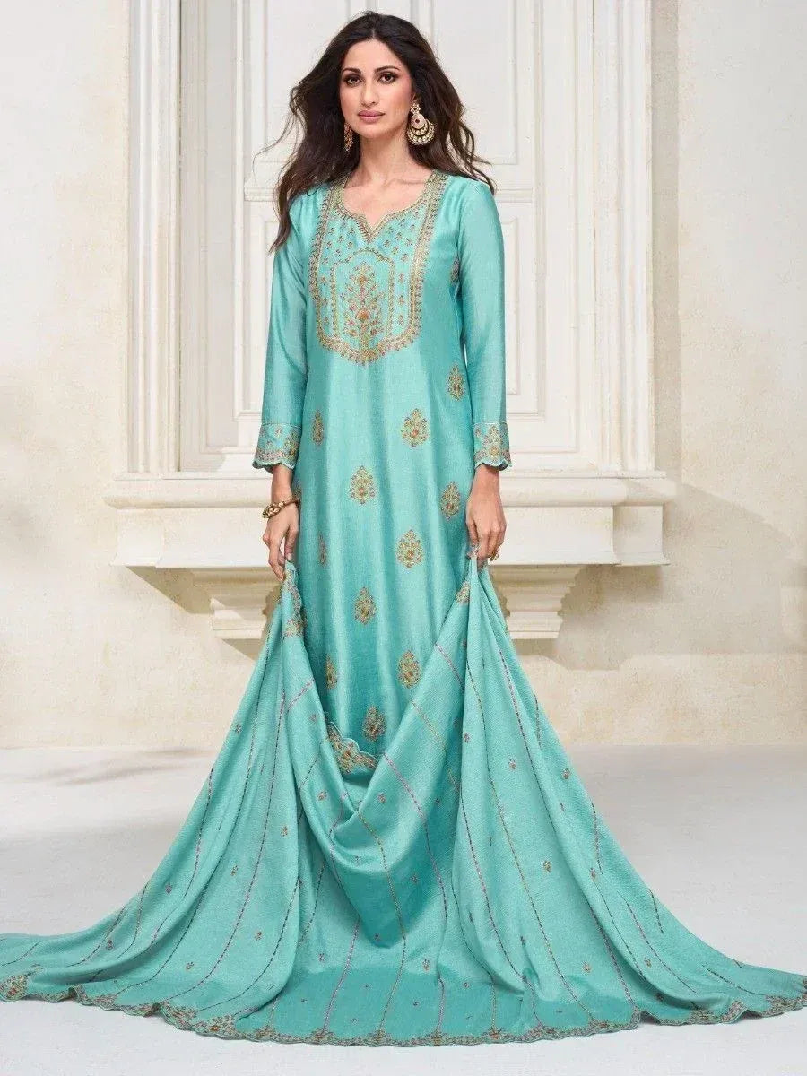 Elegant turquoise ethnic gown with gold embroidery, perfect for Indian celebrations