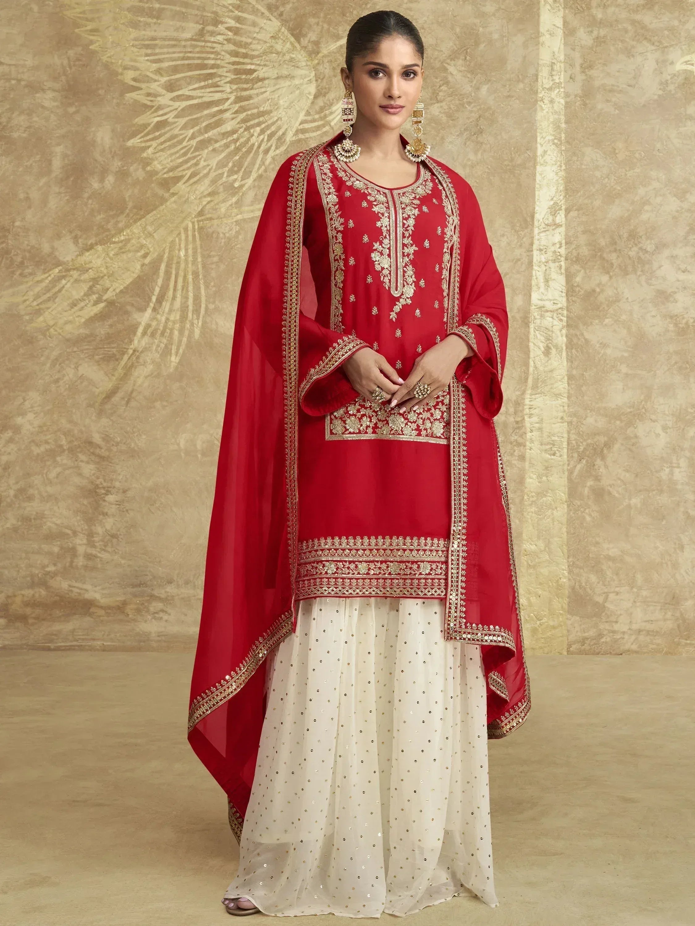 Red and white embroidered Indian salwar kameez with gold detailing and dupatta, perfect for festive occasions