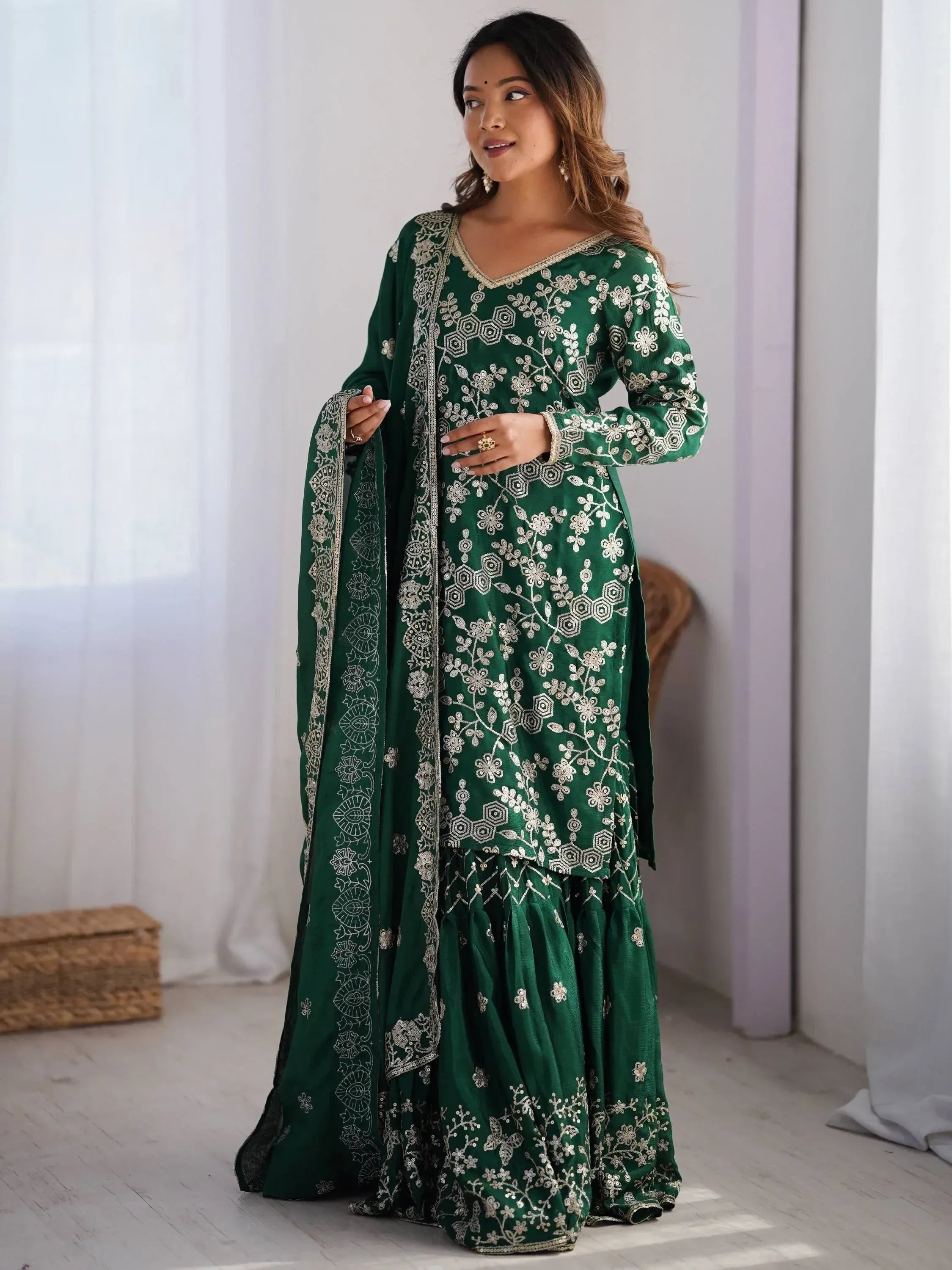Emerald green embroidered salwar kameez with floral motifs and matching dupatta, ideal for Indian ethnic wear.