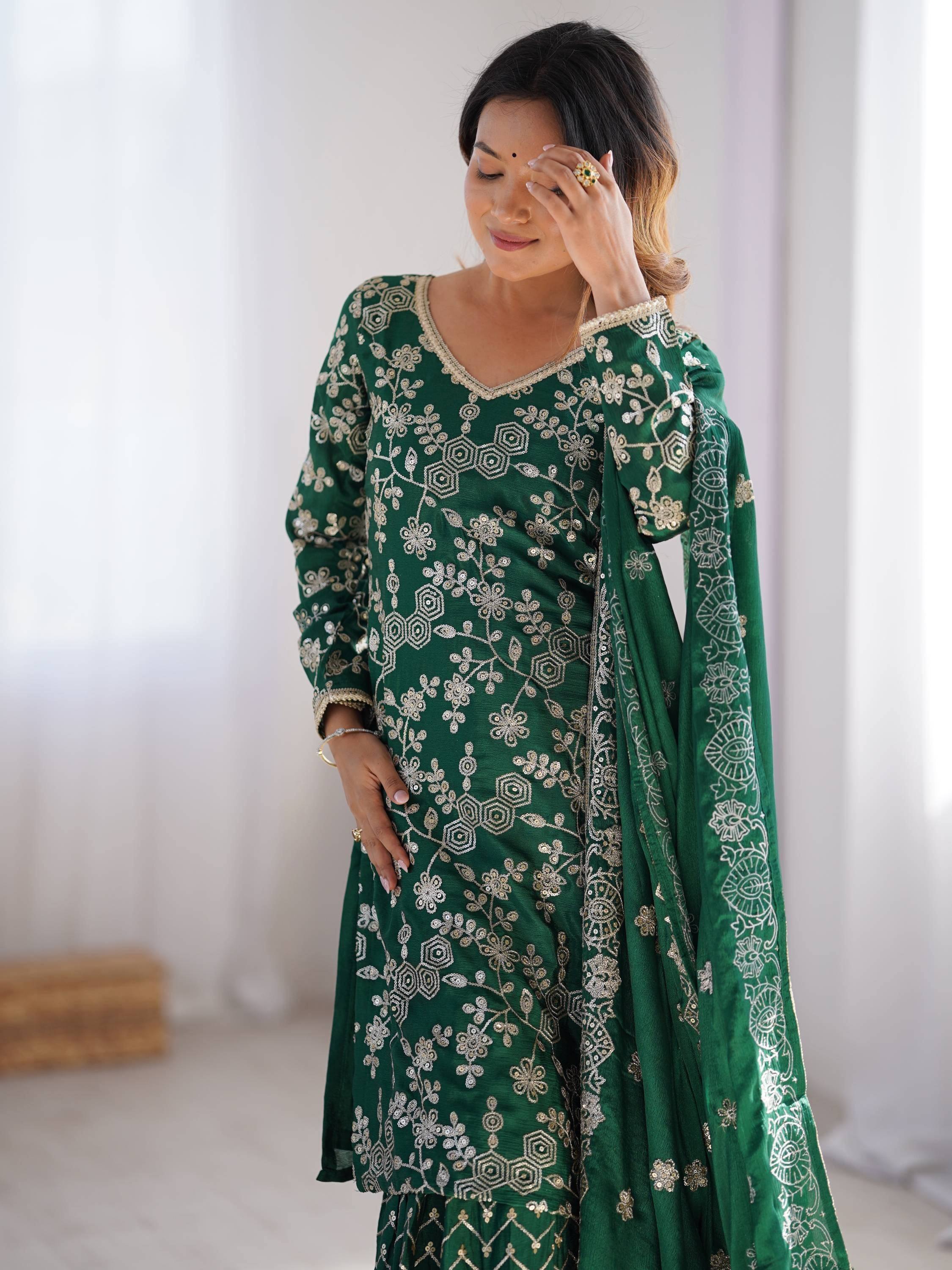 Green embroidered salwar kameez with floral and geometric designs, perfect for ethnic occasions.
