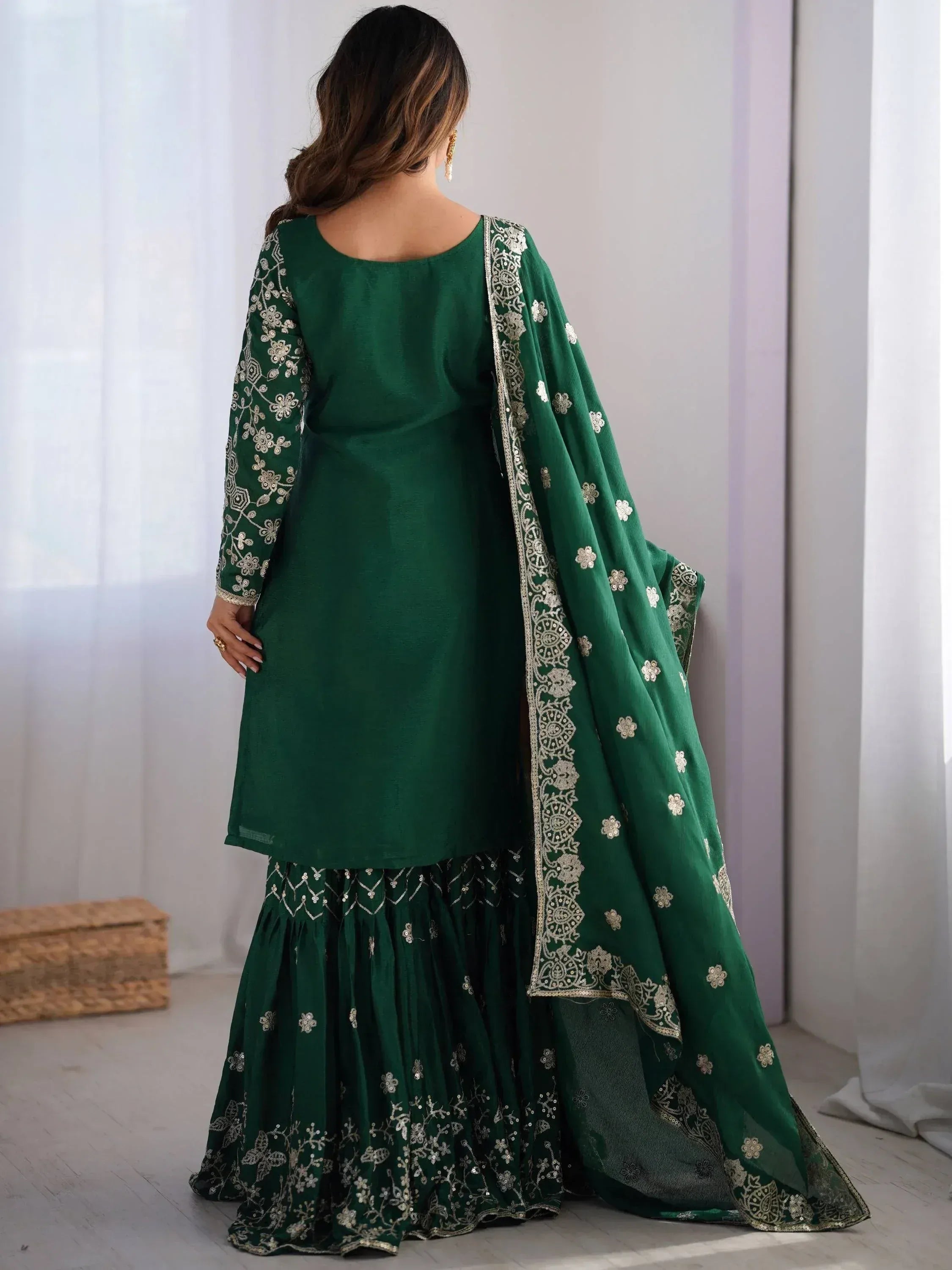 Emerald green embroidered salwar kameez with floral detailing and matching dupatta