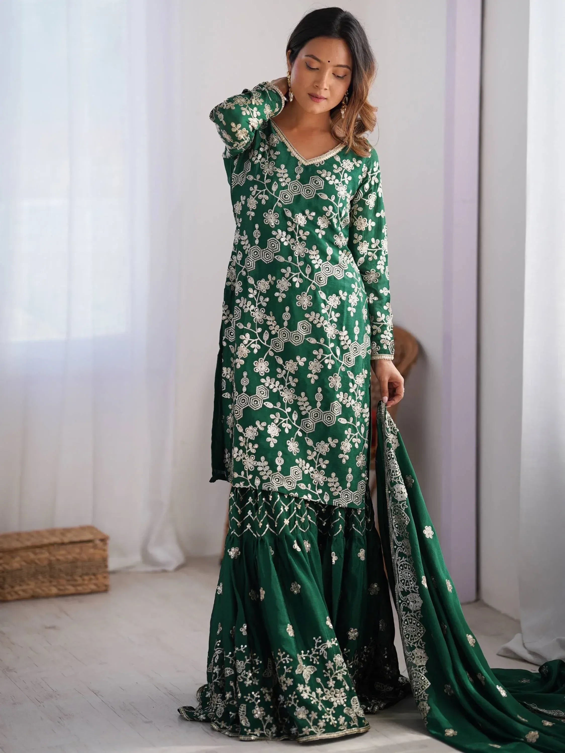 Emerald green embroidered salwar kameez with floral motifs and matching dupatta, ideal for ethnic occasions